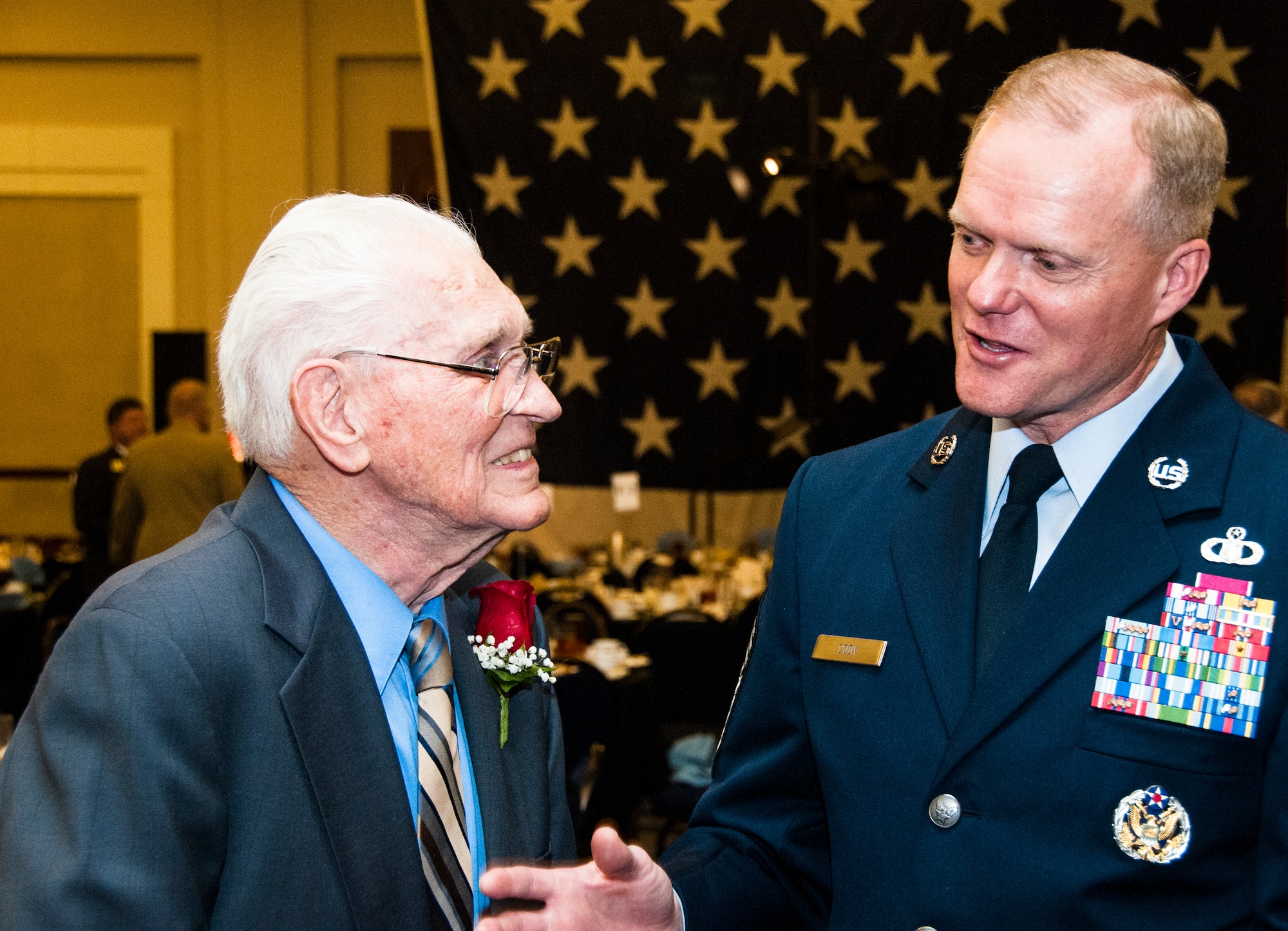 Chief Master Sgt. of the Air Force James A. Cody talks with Armi Armitage, a B-25 pilot from the Korean War, at the Atlanta Regional Military Appreciation Committee in Marietta, Ga. Nov. 17, 2014. Cody spoke the ARMAC for its 62nd annual luncheon. (U.S. Air Force photo by Senior Airman Daniel Phelps/Released)