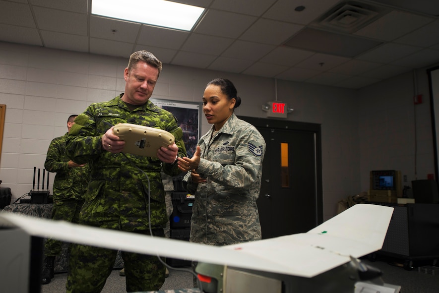 U.S. Air Force Staff Sgt. Rodshede Roberts, 820th Combat Operations Squadron technologies NCO, demonstrates how to use an RQ-11B Raven small unmanned aircraft system to Canadian forces Col. Robert Delaney, Department of National Defence provost marshal, Nov. 19, 2014, at Moody Air Force Base, Ga. Delaney visited Moody and the 820th BDG to learn about the group’s defense capabilities and procedures. (U.S. Air Force photo by Airman 1st Class Dillian Bamman/Released)