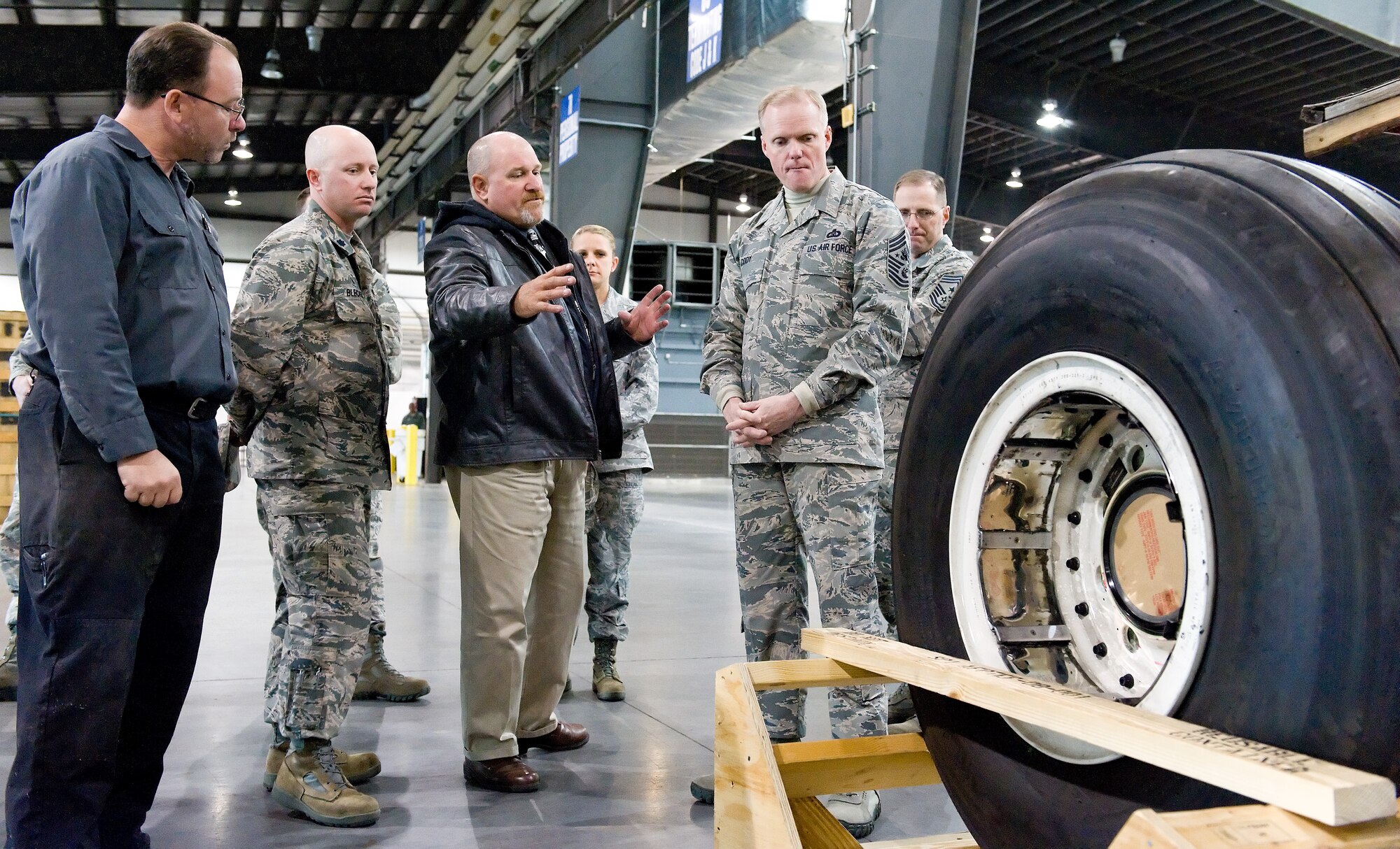 James Ewing, 436th Aerial Port Squadron operations manager, explains the crating and shipping requirements of a C-5 aircraft main landing gear wheel and tire assembly to Chief Master Sgt. of the Air Force James Cody Nov. 18, 2014, on Dover Air Force Base, Del. Cody toured the largest Aerial Port in the Department of Defense and met with numerous aerial port members. (U.S. Air Force photo/Roland Balik)