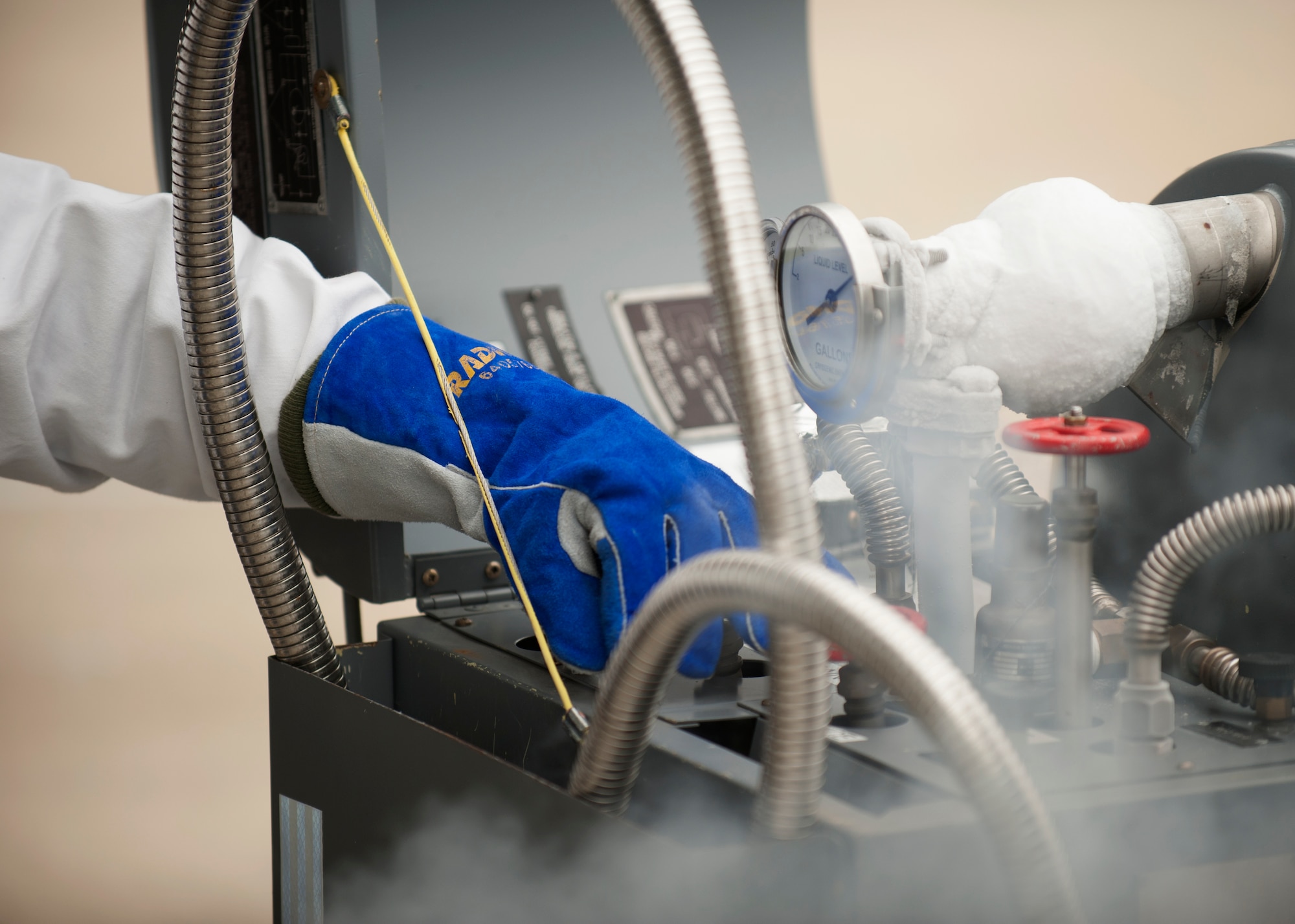 Senior Airman Richard Hayes, a 19th Logistics Readiness Squadron fuels facility operator, shuts off the fill valve on a liquid oxygen tank Nov. 13, 2014, at Little Rock Air Force Base, Ark. If hydrocarbons such as oil and other petroleum products come into contact with the liquid oxygen, it could result in a violent or potentially explosive reaction. (U.S. Air Force photo by Airman 1st Class Scott Poe) 