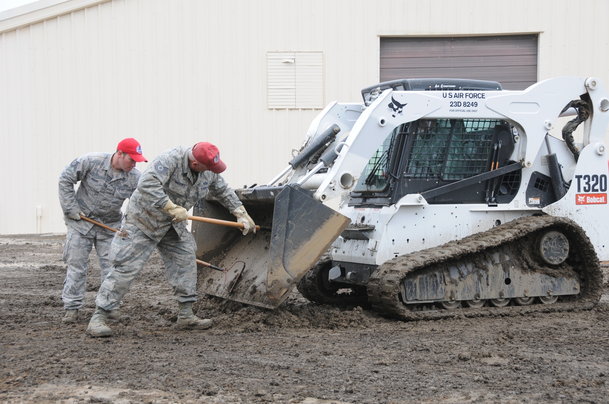 Members of the 567th Rapid Engineers Deployable Heavy Operations Repair Squadron Engineers (RED HORSE) Squadron (RHS) replace a gravel parking area with a concrete parking lot at Ebbing Air National Guard Base, Fort Smith, Ark., Nov. 5, 2014. The 567th RHS ventured to Ebbing Air National Guard Base to retrain on its RED HORSE capabilities with the 188th Civil Engineering Squadron. The 567th is an Air Force Reserve unit based at Seymour Johnson Air Force Base, N.C. (U.S. Air National Guard photo by Airman 1st Class Cody Martin/Released)