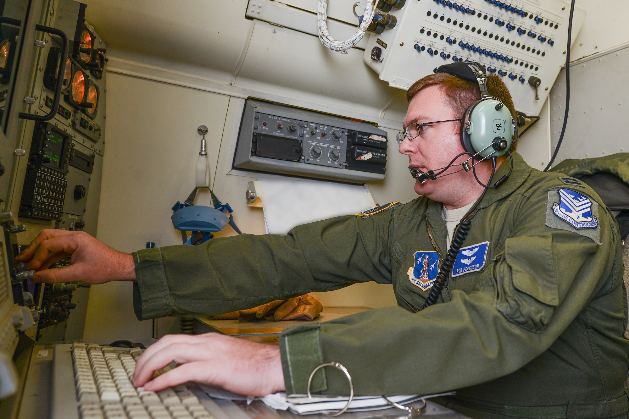 U.S. Air Force Capt. Rob Ferguson, a combat systems officer with the 116th Air Control Wing, Georgia Air National Guard, monitors and adjusts his screen at his operator work station aboard the E-8C Joint STARS aircraft during exercise Operation Carolina Thunder, Robins Air Force Base, Ga., Nov. 15, 2014.  During the exercise, Airmen and Soldiers from the 116th Air Control Wing and the 138th Military Intelligence Company provided targeting data and intelligence to F-16 Fighting Falcons, AH-64D Apache Attack Helicopters and ground forces using the one-of-a-kind battle management command and control, intelligence, surveillance and reconnaissance capabilities of the E-8C Joint STARS. The exercise was a multi-state, multi-component, collective training exercise conducted during the South Carolina drill weekend. It involved more than 650 participants from South Carolina, North Carolina, Georgia and Tennessee National Guard units. (Portion of photo blurred for security purposes) (U.S. Air National Guard photo by Tech. Sgt. Regina Young/released)