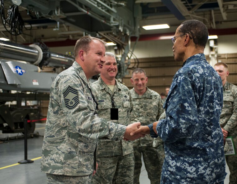 Adm. Cecil D. Haney, U.S. Strategic Command (USSTRATCOM) commander, presents a coin to Chief Master Sgt. Dan Willand, 705th Munitions Squadron air launch cruise missile flight chief, in the weapons storage area on Minot Air Force Base, N.D., Nov. 17, 2014. As part of his ongoing series of visits with nuclear deterrent forces personnel, Haney viewed 705th MUNS Airmen conducting maintenance and training in both high and low maintenance. The 5th Bomb Wing and 91st Missile Wing at Minot support USSTRATCOM’s nuclear deterrence mission set by operating and maintaining both B-52 Stratofortress bombers and Minuteman III intercontinental ballistic missiles. (U.S. Air Force photo by Senior Airman Stephanie Morris)