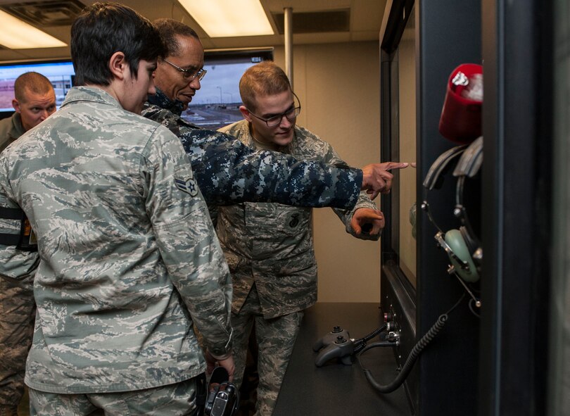Adm. Cecil D. Haney, U.S. Strategic Command (USSTRATCOM) commander, speaks with 5th Security Forces Squadron alarm monitors, Senior Airman Phil Smith and Airman 1st Class Nicolette Sheridan, in the weapons storage area at Minot Air Force Base, N.D., Nov. 17, 2014. As part of his ongoing series of visits with nuclear deterrent forces personnel, Haney viewed a digital display of the area and observed alarm procedures. The 5th Bomb Wing and 91st Missile Wing at Minot support USSTRATCOM’s nuclear deterrence mission set by operating and maintaining both B-52 Stratofortress bombers and Minuteman III intercontinental ballistic missiles. (U.S. Air Force photo by Senior Airman Stephanie Morris)