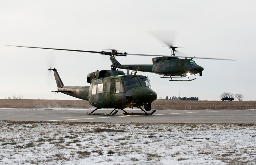 A UH-1 helicopter carrying Adm. Cecil D. Haney, U.S. Strategic Command (USSTRATCOM) commander, takes off from Minot Air Force Base, N.D., Nov. 17, 2014. As part of his ongoing series of visits with nuclear deterrent forces personnel, Haney traveled to the missile field to tour a site and view a demonstration. The 5th Bomb Wing and 91st Missile Wing at Minot support USSTRATCOM’s nuclear deterrence mission set by operating and maintaining both B-52 Stratofortress bombers and Minuteman III intercontinental ballistic missiles. (U.S. Air Force photo by Senior Airman Stephanie Morris)