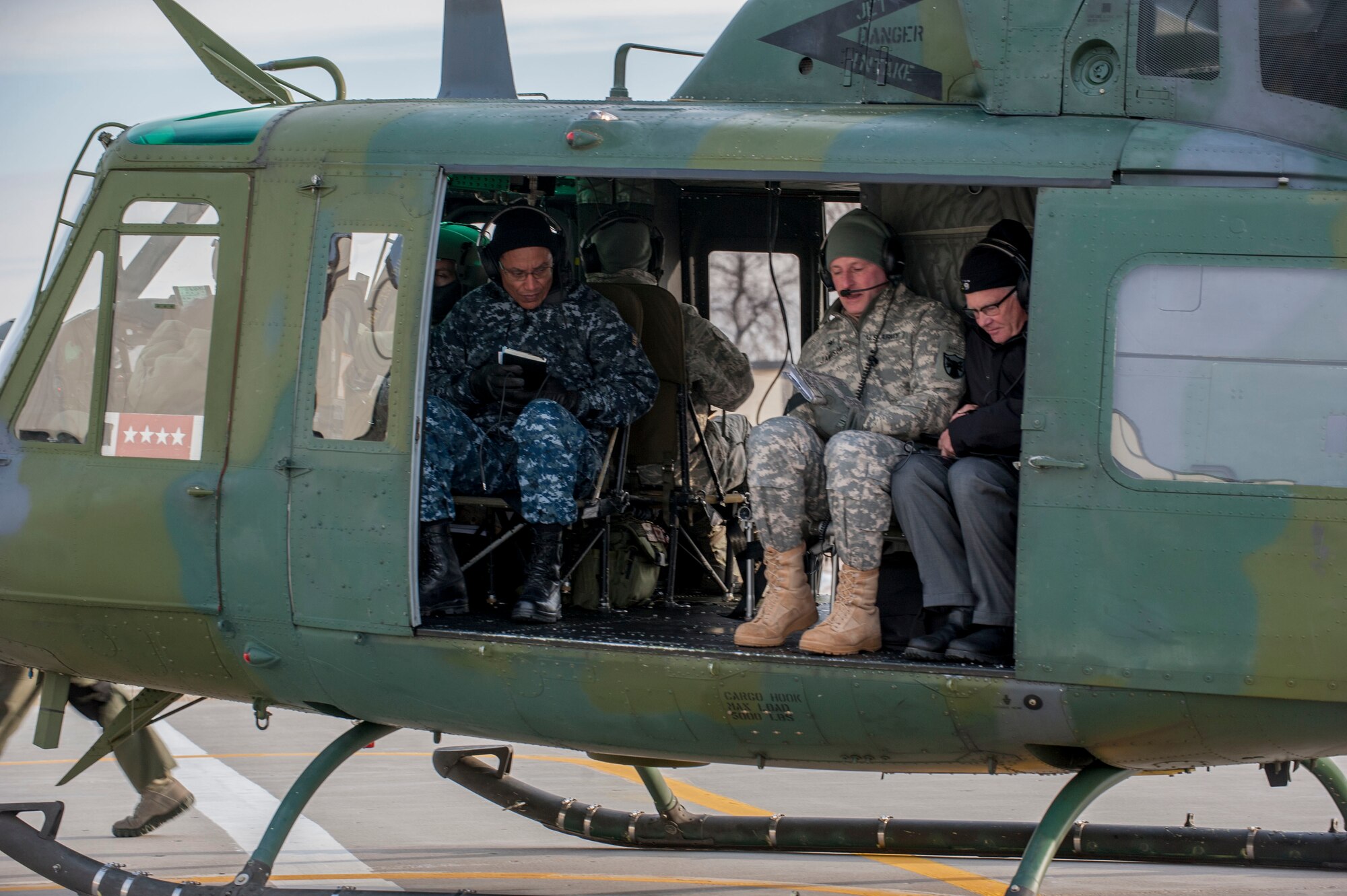 Adm. Cecil D. Haney, U.S. Strategic Command (USSTRATCOM) commander, sits aboard a UH-1 helicopter at Minot Air Force Base, N.D., Nov. 17, 2014. As part of his ongoing series of visits with nuclear deterrent forces personnel, Haney traveled to the missile field to tour a site and view a demonstration. The 5th Bomb Wing and 91st Missile Wing at Minot support USSTRATCOM’s nuclear deterrence mission set by operating and maintaining both B-52 Stratofortress bombers and Minuteman III intercontinental ballistic missiles. (U.S. Air Force photo by Senior Airman Stephanie Morris)