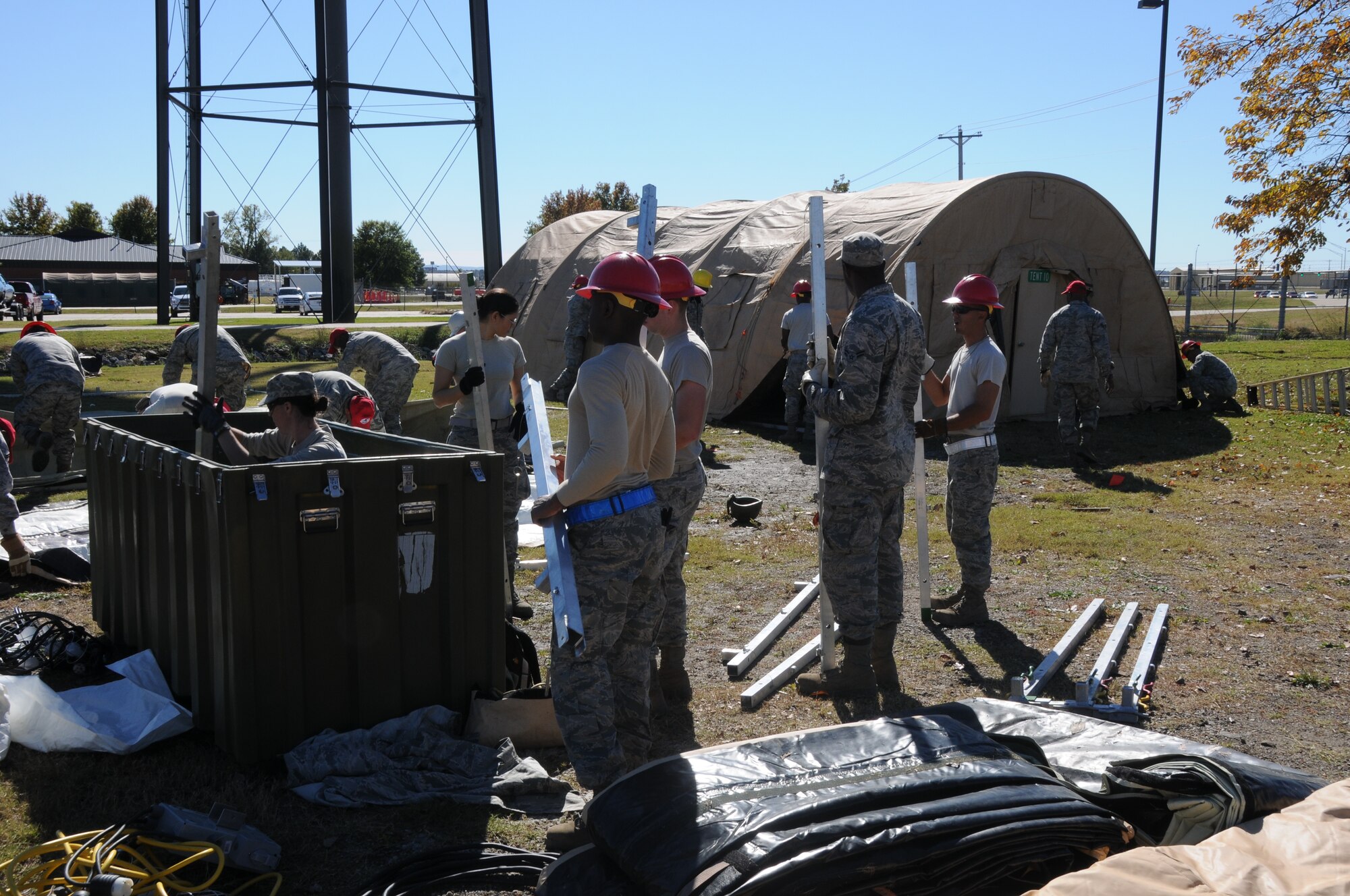 Members of the 567th Rapid Engineers Deployable Heavy Operations Repair Squadron Engineers (RED HORSE) Squadron (RHS) take down tents that were erected at Ebbing Air National Guard Base, Fort Smith, Ark., Nov. 6, 2014. The 567th RHS ventured to Ebbing Air National Guard Base to retrain on its RED HORSE capabilities with the 188th Civil Engineering Squadron. The 567th is an Air Force Reserve unit based at Seymour Johnson Air Force Base, N.C. (U.S. Air National Guard photo by Airman 1st Class Cody Martin/Released)
