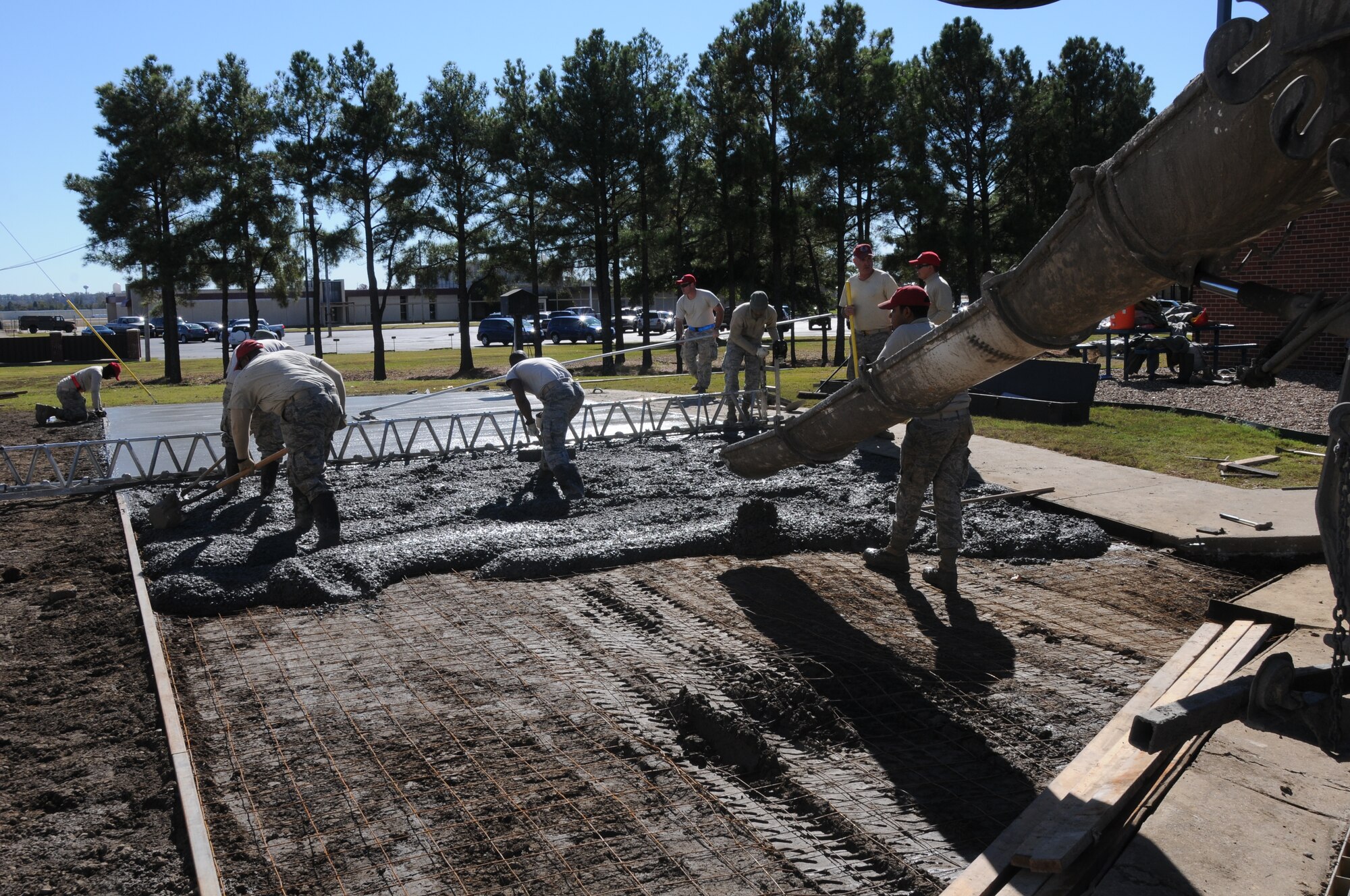 Members of the 567th Rapid Engineers Deployable Heavy Operations Repair Squadron Engineers (RED HORSE) Squadron (RHS) replace a gravel parking area with a concrete parking lot at Ebbing Air National Guard Base, Fort Smith, Ark., Nov. 6, 2014.The 567th RHS ventured to Ebbing Air National Guard Base to retrain on its RED HORSE capabilities with the 188th Civil Engineering Squadron. The 567th is an Air Force Reserve unit based at Seymour Johnson Air Force Base, N.C. (U.S. Air National Guard photo by Airman 1st Class Cody Martin/Released)