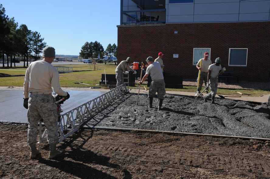 Members of the 567th Rapid Engineers Deployable Heavy Operations Repair Squadron Engineers (RED HORSE) Squadron (RHS) replace a gravel parking area with a concrete parking lot at Ebbing Air National Guard Base, Fort Smith, Ark., Nov. 6, 2014.The 567th RHS ventured to Ebbing Air National Guard Base to retrain on its RED HORSE capabilities with the 188th Civil Engineering Squadron. The 567th is an Air Force Reserve unit based at Seymour Johnson Air Force Base, N.C. (U.S. Air National Guard photo by Airman 1st Class Cody Martin/Released)