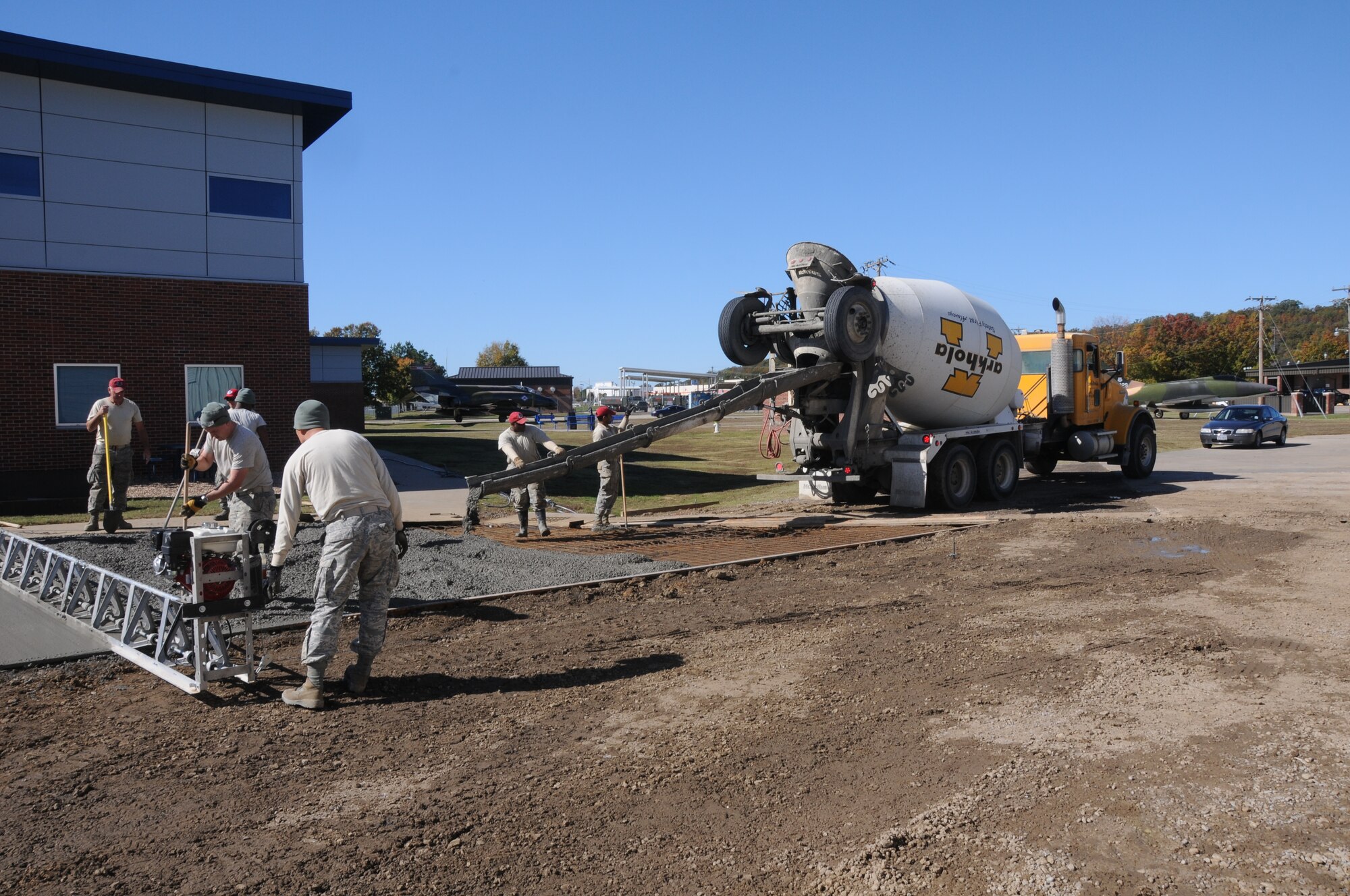 Members of the 567th Rapid Engineers Deployable Heavy Operations Repair Squadron Engineers (RED HORSE) Squadron (RHS) replace a gravel parking area with a concrete parking lot at Ebbing Air National Guard Base, Fort Smith, Ark., Nov. 6, 2014.The 567th RHS came to Ebbing Air National Guard Base to retrain on its RED HORSE capabilities with the 188th Civil Engineering Squadron. The 567th is an Air Force Reserve unit based at Seymour Johnson Air Force Base, N.C. (U.S. Air National Guard photo by Airman 1st Class Cody Martin/Released)