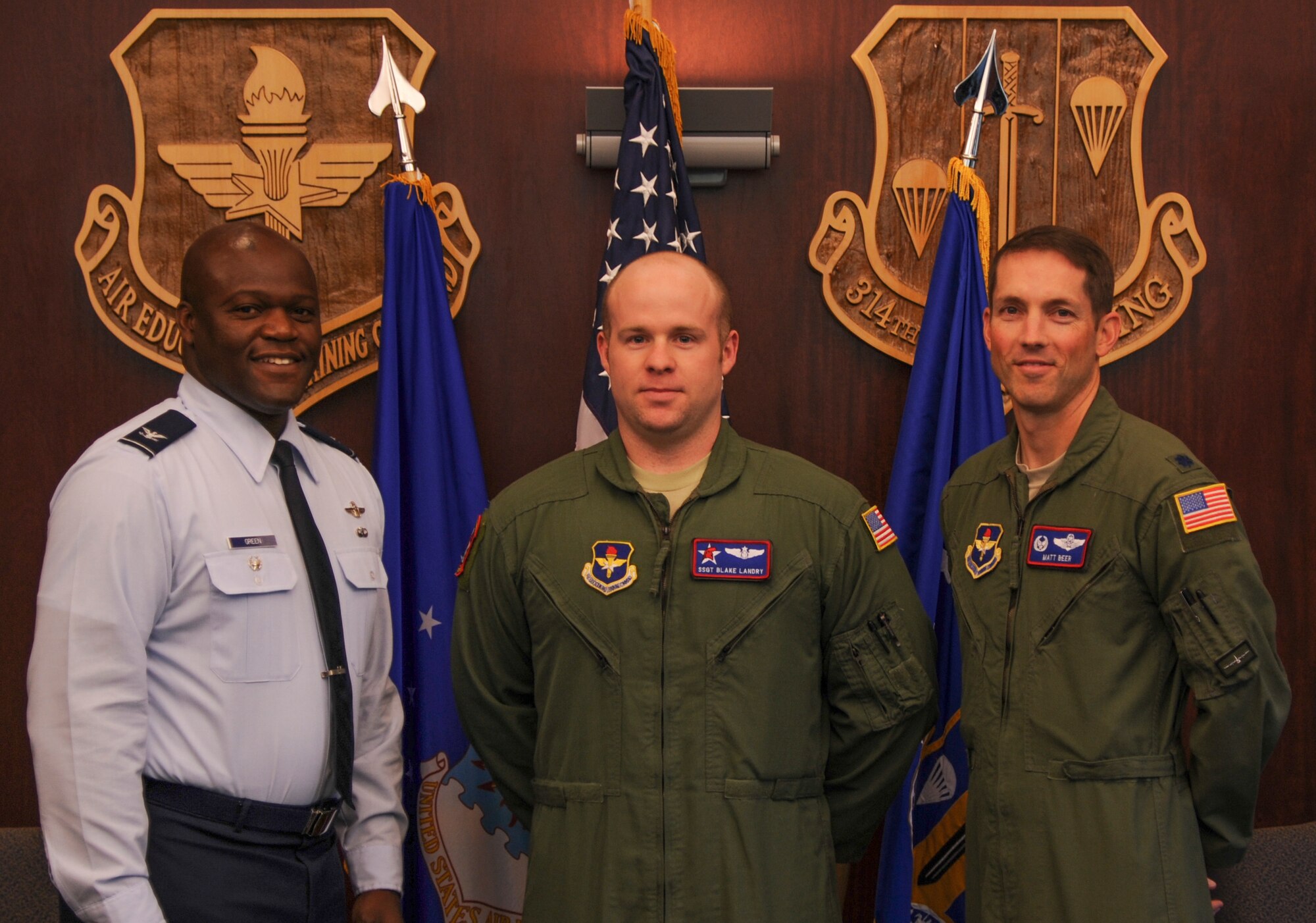 Col. Keith Green, 314th Airlift Wing vice commander, and Lt. Col. Matthew Beer, 714th Training Squadron commander, congratulate Staff Sgt. Blake Landry, 714th TRS C-130H fuselage training unit loadmaster instructor, for his selection as Combat Airlifter of the Week Nov. 18, 2014, at Little Rock Air Force Base, Ark. Landry, a Breaux Bridge, La., native, is responsible for evaluating all Lockheed Martin C-130H loadmaster instructors during academic and simulator phases of training. (U.S. Air Force photo by Airman 1st Class Harry Brexel) 