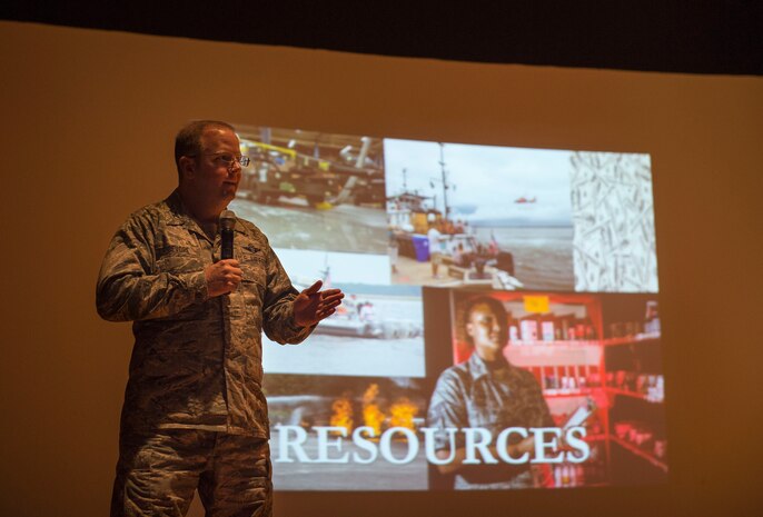 Col. Jeffery DeVore, Joint Base Charleston commander, speaks with Airmen, Sailors and civilians during one of three commander’s call held Nov. 19, 2014, at Joint Base Charleston, S.C. DeVore discussed the importance of communication, eliminating sexual assault, preventing drinking and driving, force management and force support finances for 2015. (U.S. Air Force photo/ Senior Airman Jared Trimarchi)