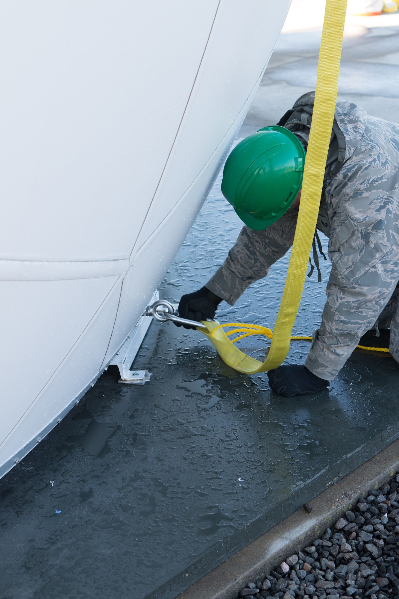 An Airman from the 103rd Air Control Squadron secures a strap to a fiber composite radome moments before it’s lifted to the top of the radar tower at the Orange Air National Guard Station, Orange, Conn., Oct. 25, 2014.  The radome is a maintenance free protective shield that protects the $2 million antenna within from possible wind damage during severe weather.  (Photo courtesy of Senior Master Sgt. Keith Haessly)