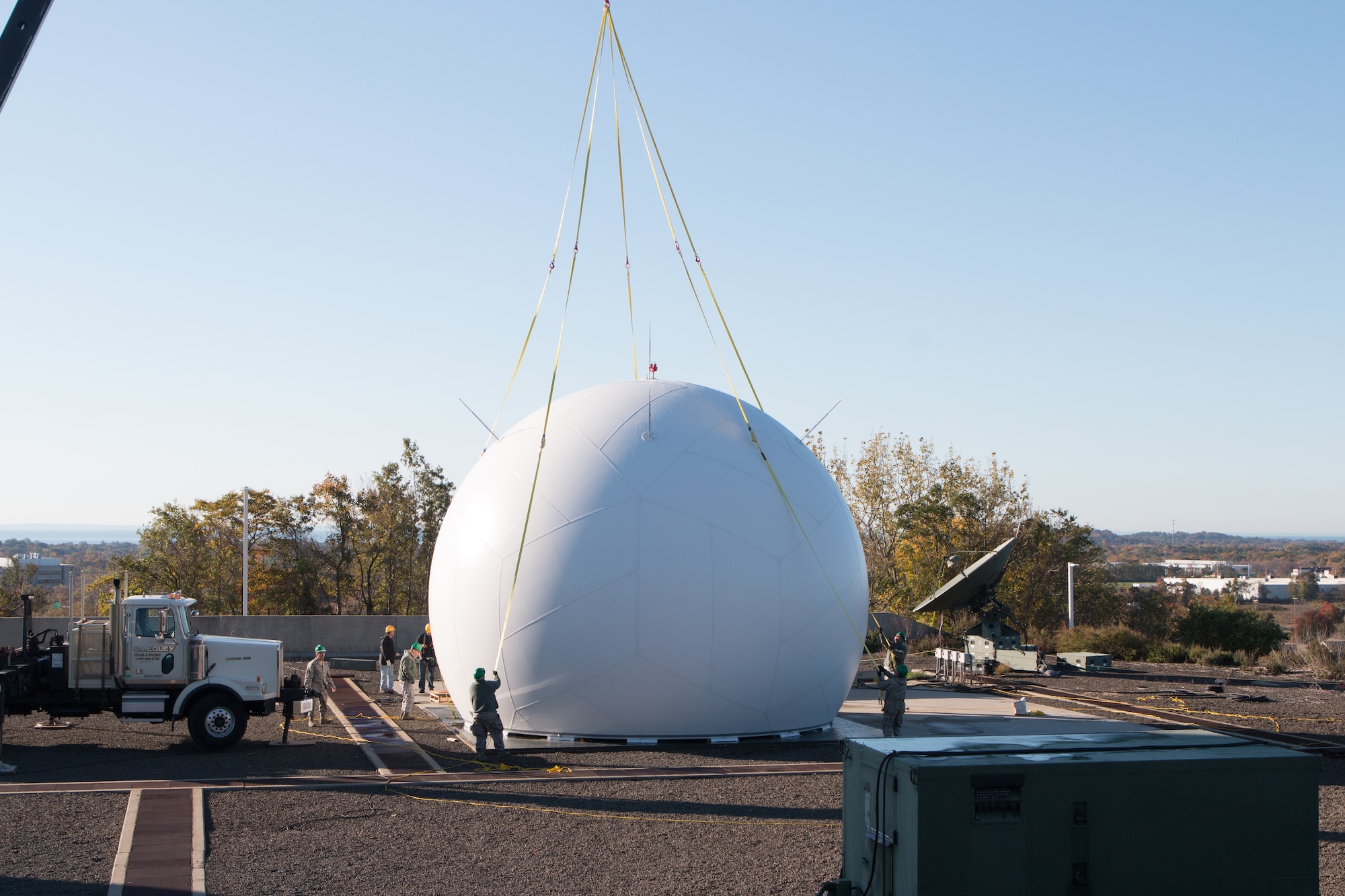 Airmen from the 103rd Air Control Squadron raise a fiber composite radome to the top of the radar tower at the Orange Air National Guard Station, Orange, Conn., Oct. 25, 2014.  The maintenance free radome, which gets its name from a blend of the words radar and dome, is a protective shield that encompasses a radar antenna eliminating the need to fold and protect the $2 million antenna within from possible wind damage during severe weather.  (Photo courtesy of Senior Master Sgt. Keith Haessly)