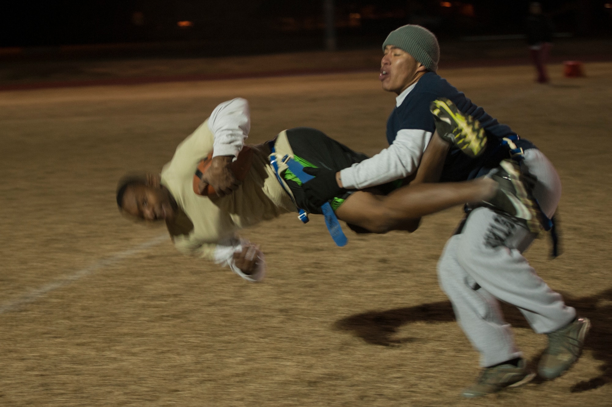 Staff Sgt. Victor White, a 19th Maintenance Squadron wide receiver, gets tripped up while trying to get a first down Nov. 17, 2014, at Little Rock Air Force Base, Ark. (U.S. Air Force photo by Senior Airman Kaylee Clark)