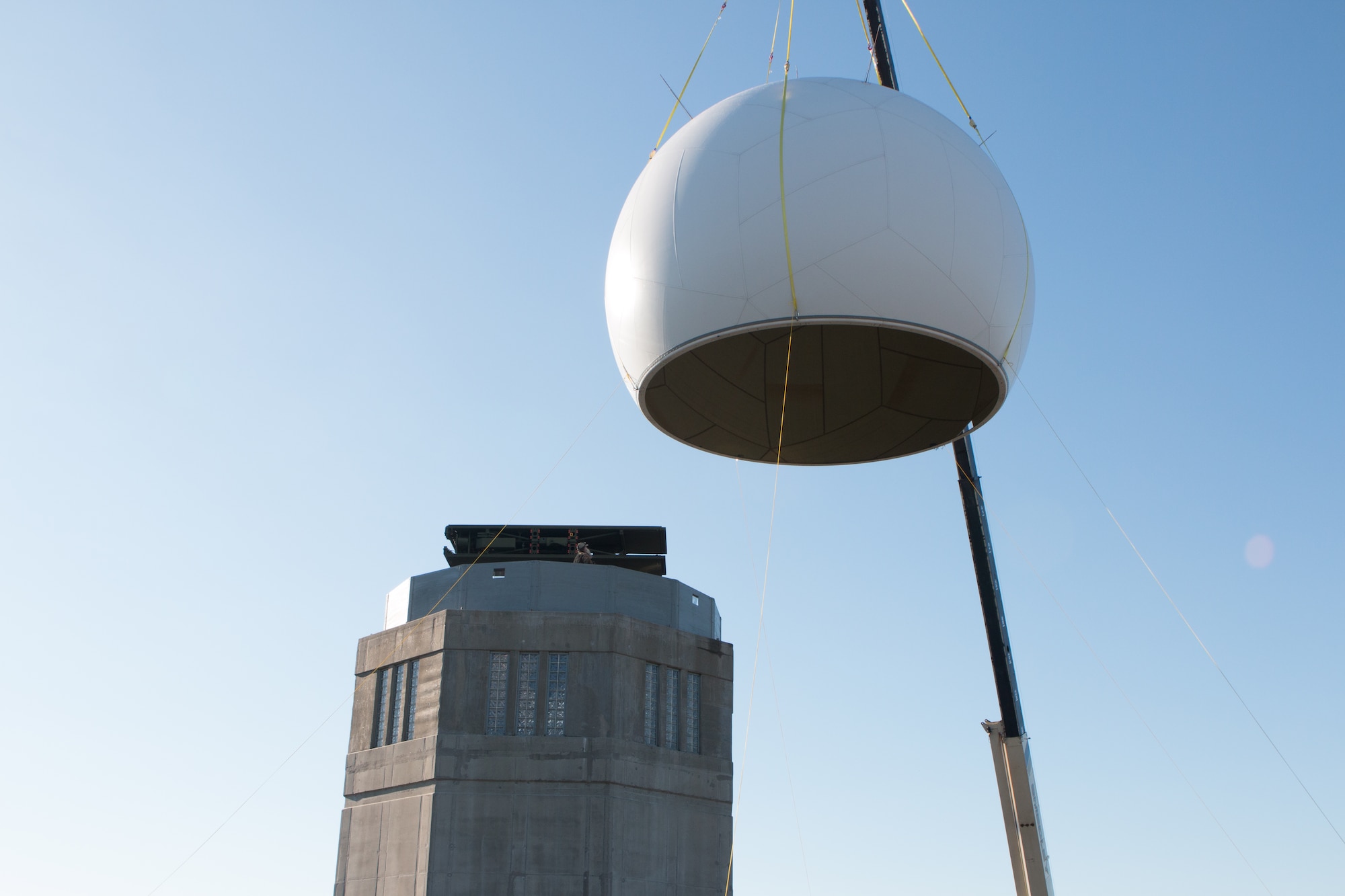 Airmen from the 103rd Air Control Squadron raise a fiber composite radome on to the radar tower at the Orange Air National Guard Station, Orange, Conn., Oct. 25, 2014.  The maintenance free radome, which gets its name from a blend of the words radar and dome, is a protective shield that encompasses a radar antenna to eliminate the need to fold and protect the $2 million antenna within from possible wind damage during severe weather.  (Photo courtesy of Senior Master Sgt. Keith Haessly)
