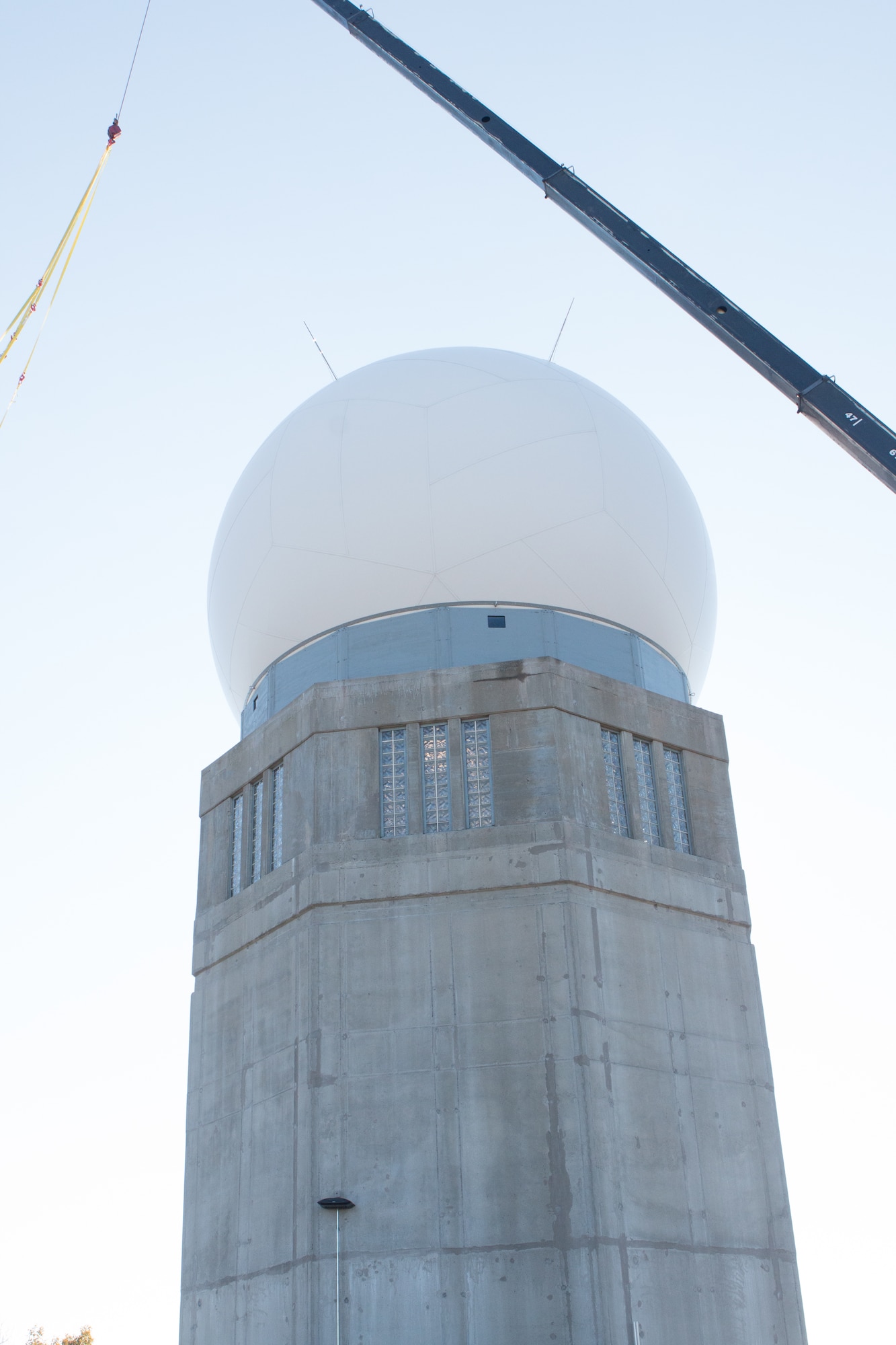 A newly installed fiber composite radome shields a tactical radar antenna at the top of the radar tower at the Orange Air National Guard Station, Orange, Conn., Oct. 25, 2014.  The maintenance-free radome is a protective shield that eliminates the need to fold and protect the $2 million antenna within from possible damage during severe weather, enabling the Airmen of the 103rd Air Control Squadron to focus on other mission priorities.  (Photo courtesy of Senior Master Sgt. Keith Haessly)