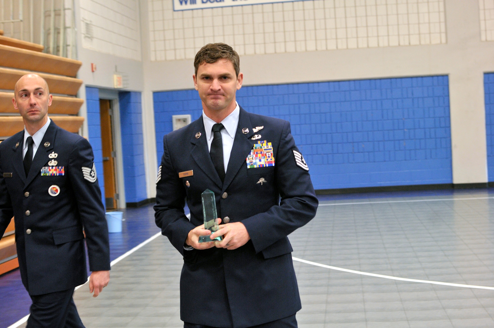 MCGHEE TYSON AIR NATIONAL GUARD BASE, Tenn. - Tech. Sgt. Michael S. Young, right, from the 38th Rescue Squadron, Moody Air Force Base, Ga., returns to his seat after receiving the Commandant's Award at the I.G. Brown Training and Education Center here Nov. 20 for his achievements in NCO Academy. (U.S. Air National Guard photo by Master Sgt. Mike R. Smith/Released)