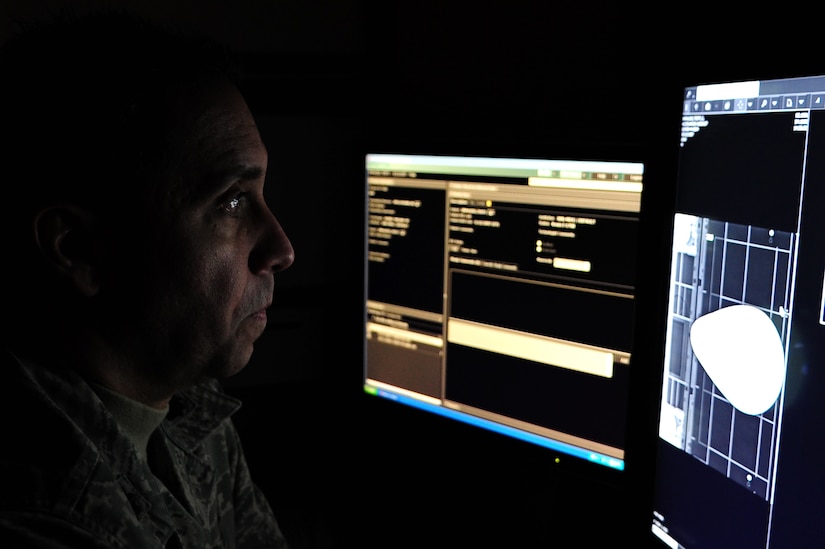 U.S. Air Force Lt. Col. Elliot Pinero, 633rd Surgical Operations Squadron Diagnostics Imaging Flight commander, reviews magnetic resonance imaging scans at Langley Air Force Base, Va., Nov. 14, 2014. MRIs are used on patients for medical diagnosis, staging of disease and for follow-up, without exposure to ionizing radiation. (U.S. Air Force photo by Airman 1st Class Areca T. Wilson/Released) 