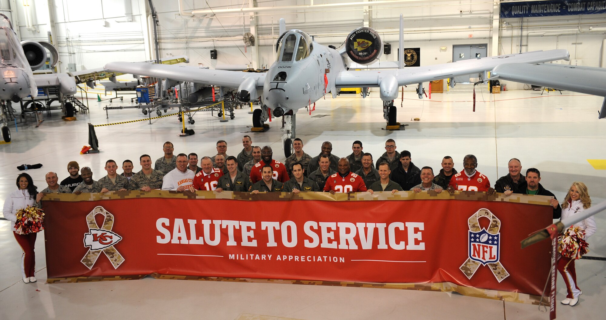 Members of Team Whiteman pose in front of an A-10 Warthog with Kansas City Chiefs cheerleaders and retired players at Whiteman Air Force Base, Mo., Nov. 18, 2014. The Chiefs annual visit is part of their community outreach program. (U.S. Air Force photo by Airman 1st Class Joel Pfiester/Released)
