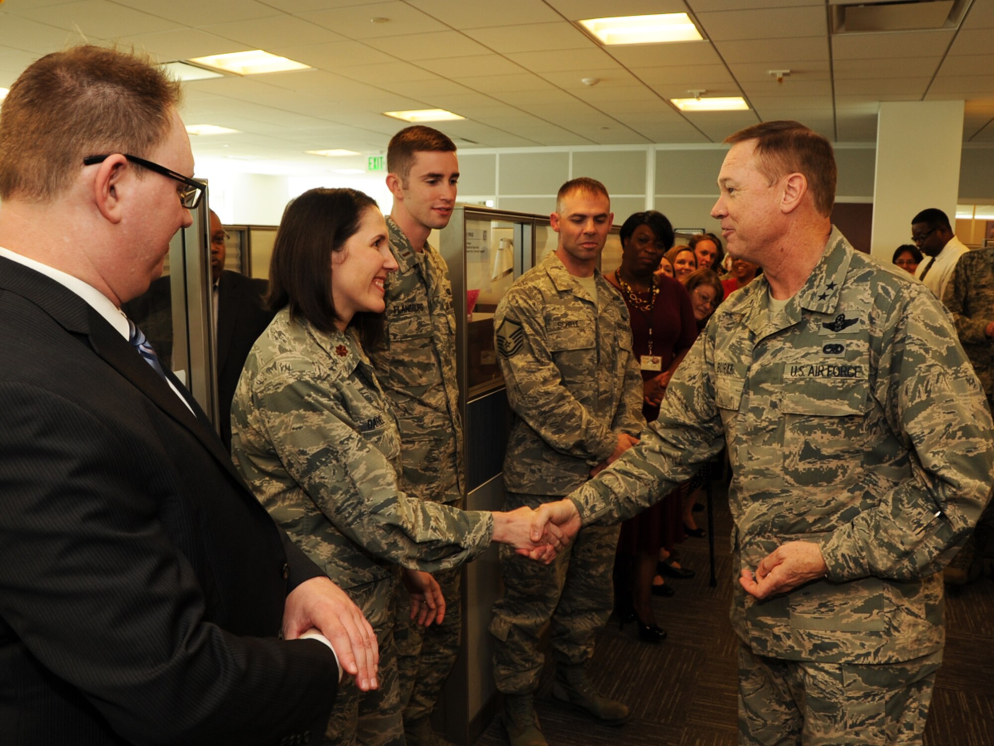 Maj. Gen. Darryl Burke, Air Force District of Washington commander, coins AFDW Contracting Airmen and civilians for their work with the Secretary of Defense Travel Team on Joint Base Andrews, Md., Oct. 28, 2014. The AFDW Contracting Directorate provides support for many National Capital Region and worldwide Department of Defense agencies. (U.S. Air Force photo/Staff Sgt. Matt Davis)
