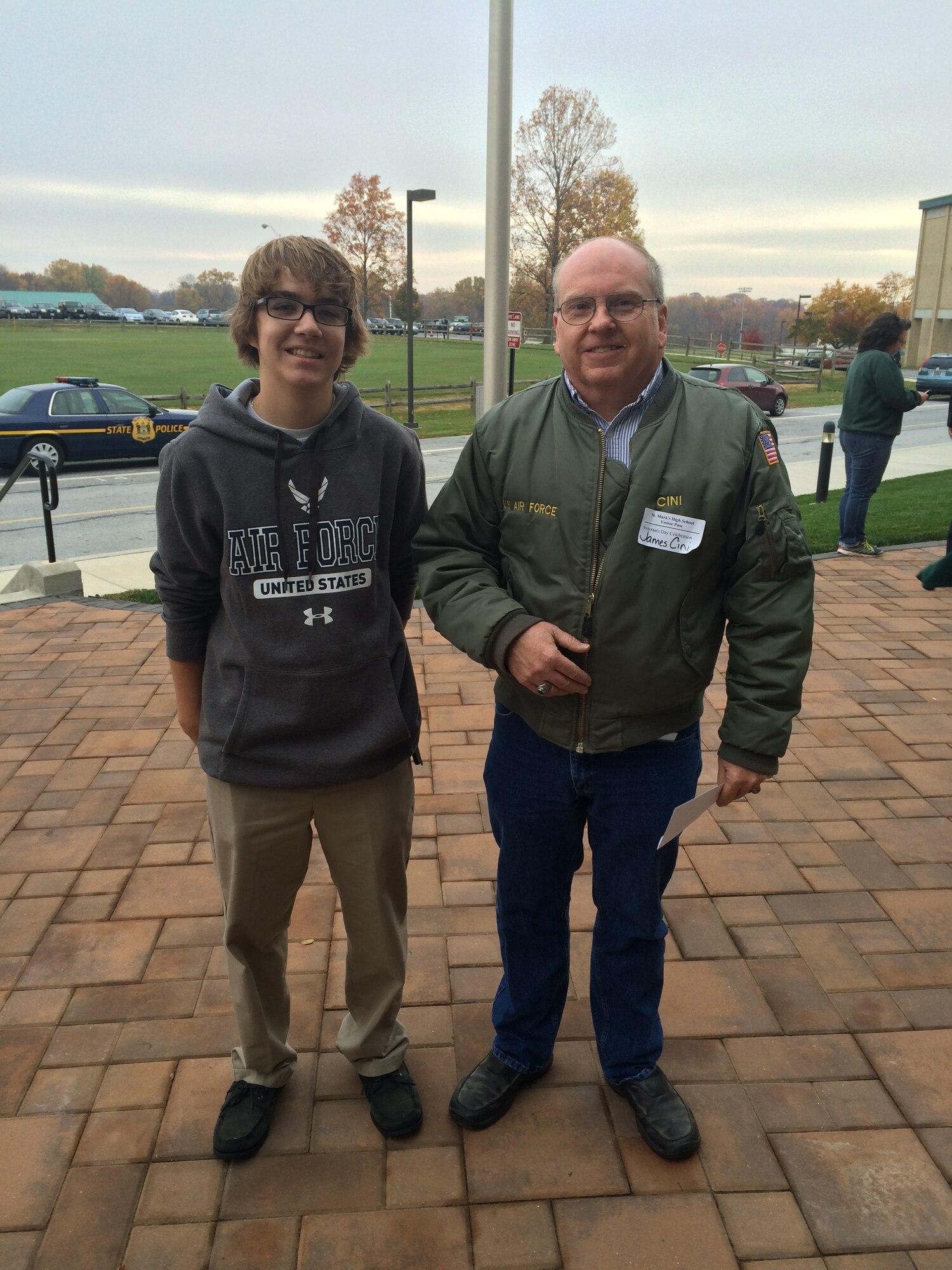 Tech. Sgt. James Cini, 709th Airlift Squadron, stands with Aaron Young, the newest member of the 709th AS loadmaster section, following a Veterans Day Ceremony Nov. 11, 2014, at St. Mark’s High School in Wilmington, Del. Cini graduated from St. Mark’s in 1980, and Young, a senior at St. Mark’s, is slated to attend Basic Military Training and loadmaster technical training after his 2015 graduation.  (Courtesy photo)