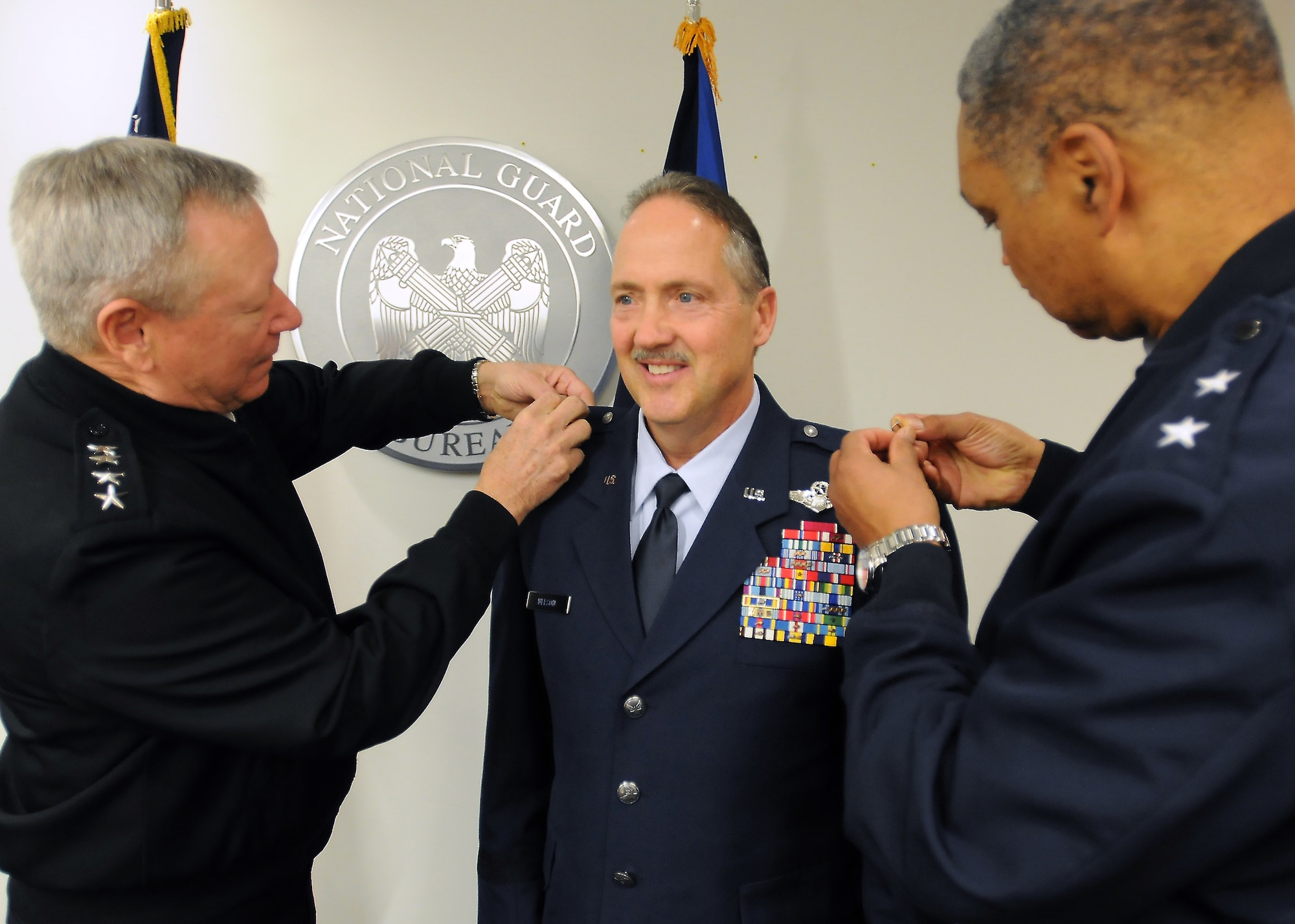 U.S. Army Gen. Frank Grass (left), chief of the National Guard Bureau, promotes Greg Nelson, vice director of Strategic Plans, Policy and International Affairs at the National Guard Bureau, to the rank of brigadier general during a ceremony at the National Guard Readiness Center in Arlington, Va., Nov. 19, 2014. Nelson served as commander of the Kentucky Air National Guard’s 123rd Airlift Wing in Louisville from 2008 to 2012. (U.S. Army National Guard photo by Staff Sgt. Michelle Gonzalez)
