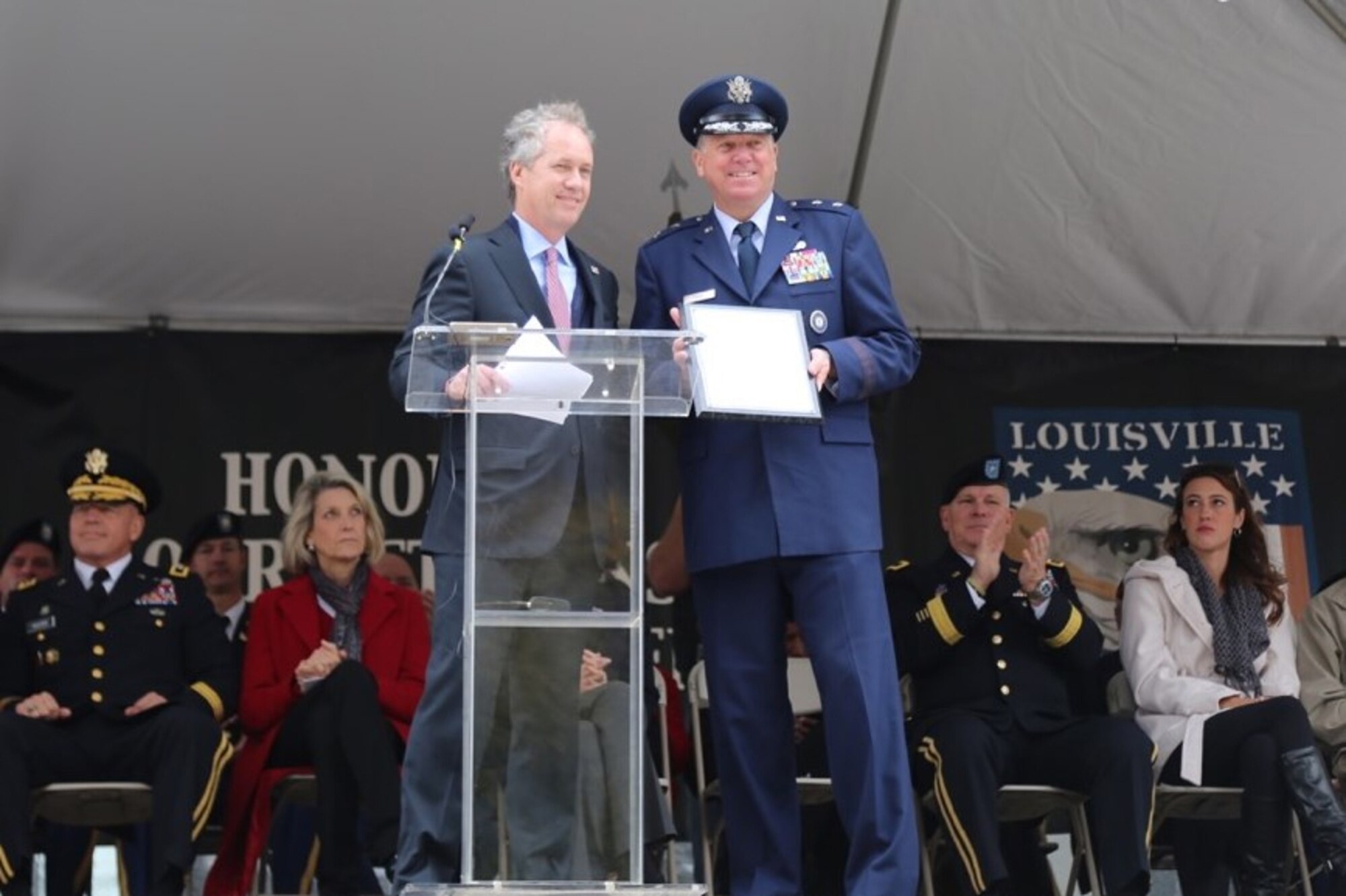 Louisville, Ky., Mayor Greg Fischer presents Kentucky’s adjutant general, Maj. Gen. Edward W. Tonini, with a plaque honoring the Kentucky National Guard during a Veterans Day ceremony in Louisville Nov. 11, 2014. The mayor referred to the Kentucky National Guard as the “best of the best” for its service to the community, commonwealth and nation. (Kentucky National Guard photo by Olivia Burton)