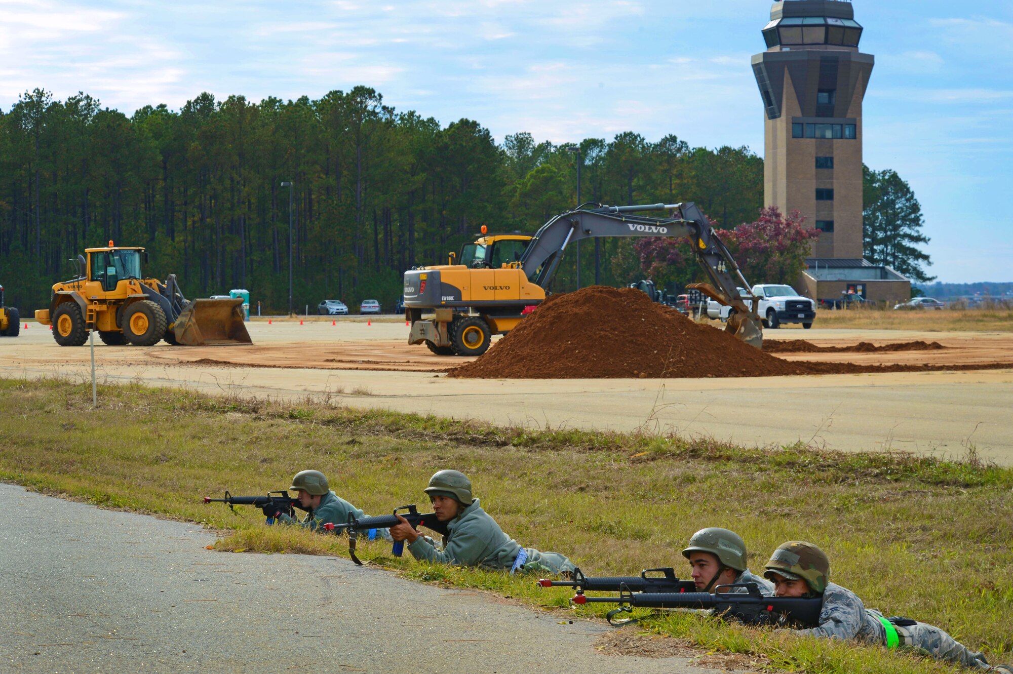 U.S. Air Force Airmen assigned to the 20th Civil Engineer Squadron return fire at simulated enemy targets during Operational Readiness Exercise Weasel Victory 15-01 at Shaw Air Force Base, S.C., Nov. 18, 2014. The Airmen returned fire after opposing forces dropped a simulated bomb on the mock runway. (U.S. Air Force photo by Airman 1st Class Jensen Stidham/Released)