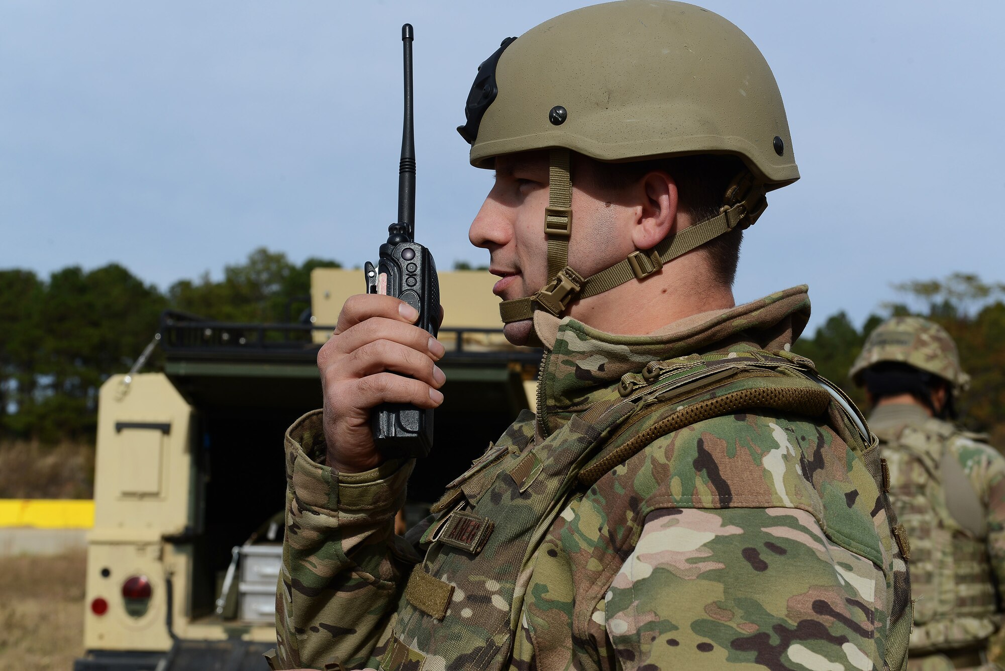 U.S. Air Force Staff Sgt. Ryan Nielsen, 20th Civil Engineer Squadron explosive ordnance disposal technician, speaks on the land mobile radio to clear the simulated runway before simulating the disposal of an unexploded ordnance during Operational Readiness Exercise Weasel Victory 15-01 at Shaw Air Force Base, S.C., Nov. 18, 2014. Nielsen ensured the safety of 20th Civil Engineer Squadron Airmen working on the runway before detonating the simulated explosive. (U.S. Air Force photo by Airman 1st Class Diana M. Cossaboom/Released)