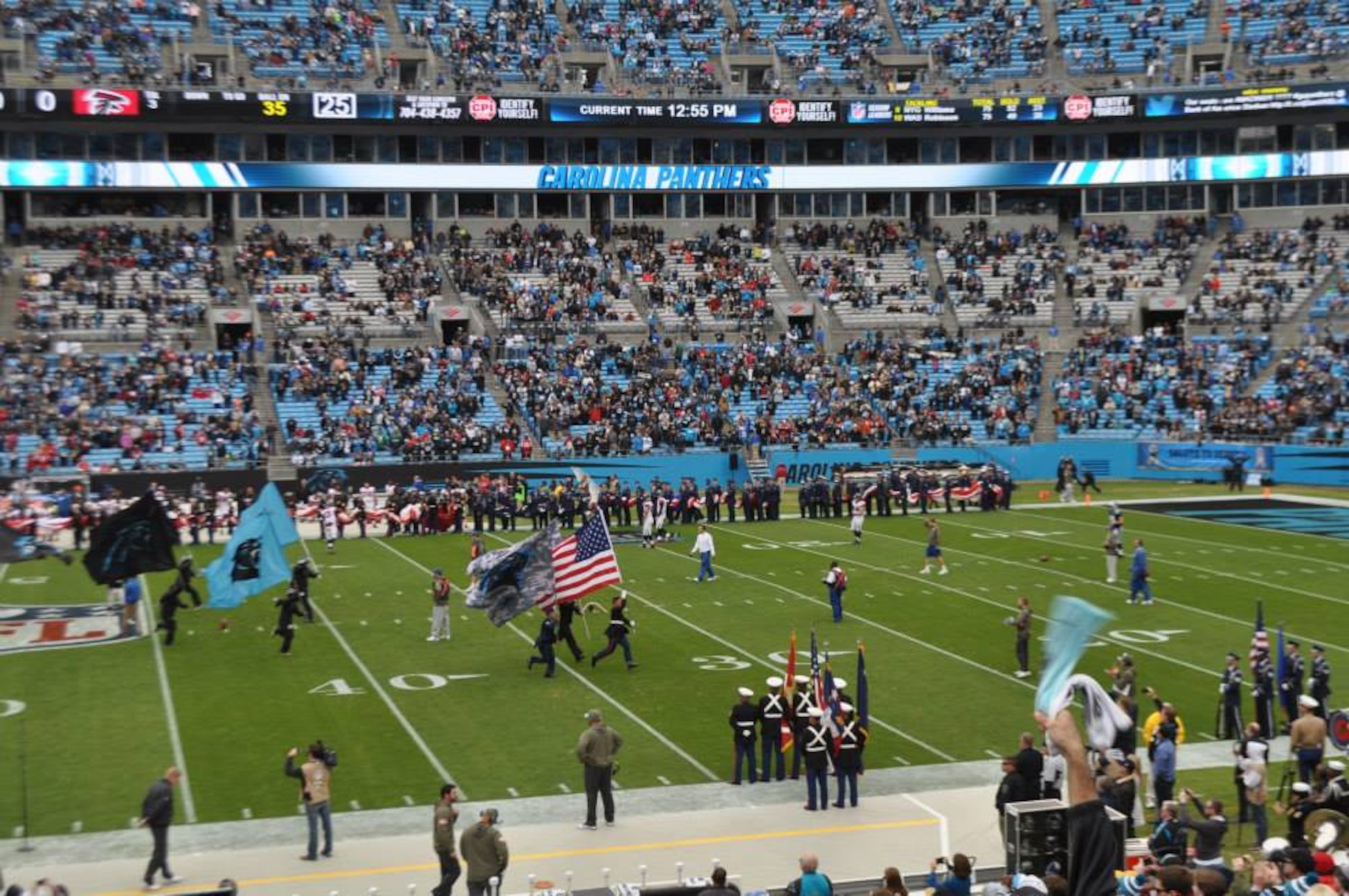 Service members run onto the field before the start of the game at the Carolina Panthers Salute to Service game at Bank of America Stadium, Charlotte, N.C., Nov. 16, 2014. Service members from all five branches of the military ran onto the field with the Panthers before the start of the game. (Courtesy photo)