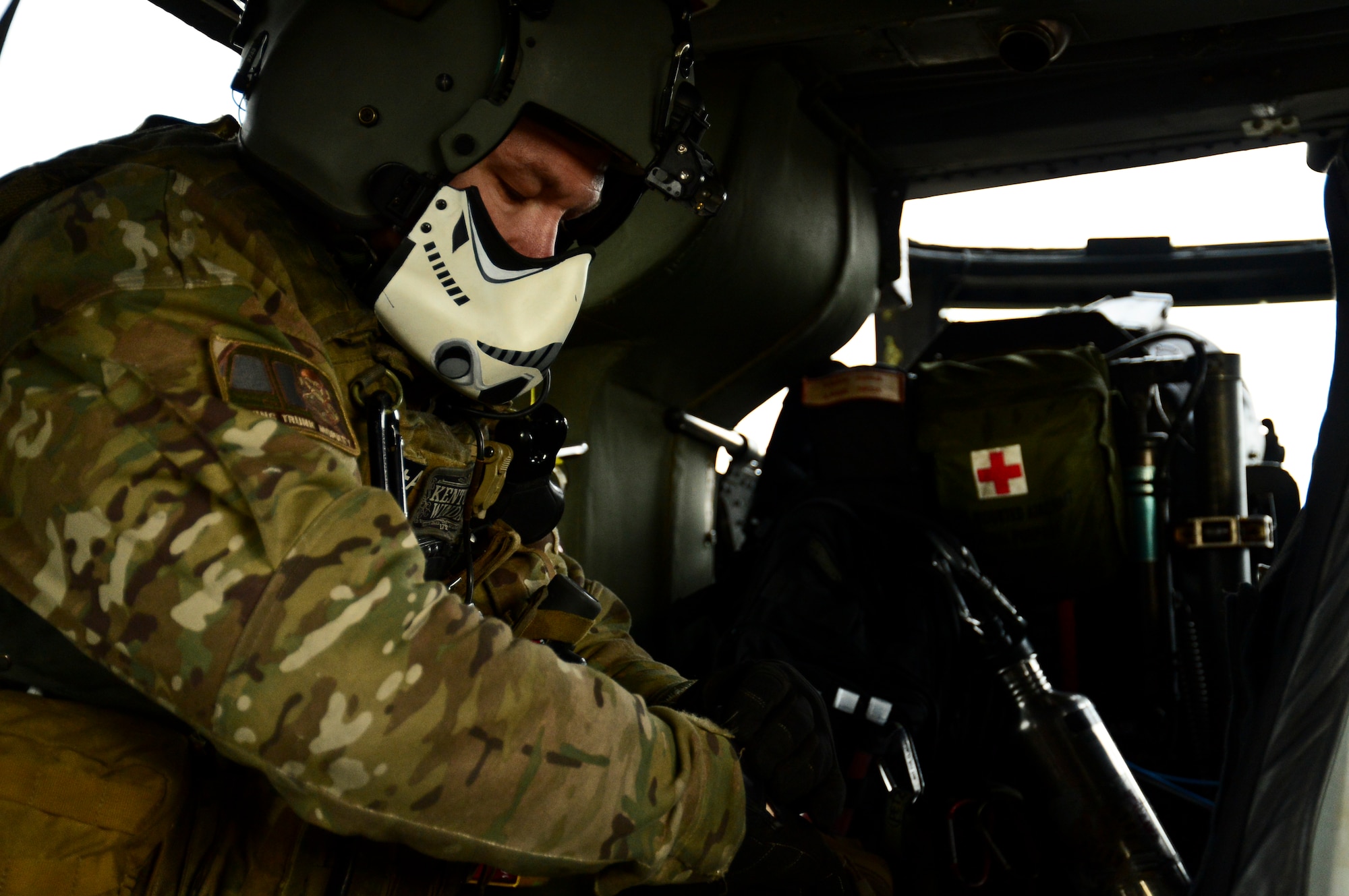 Staff Sgt. Adam Rifas, 56th Rescue Squadron special mission aviator, runs through a checklist before a training sortie at Royal Air Force Lakenheath, England, Nov. 12, 2014. Traditions of the 56th Rescue Squadron are steeped in history. (U.S. Air Force photo by Airman 1st Class Erin R. Babis/Released)