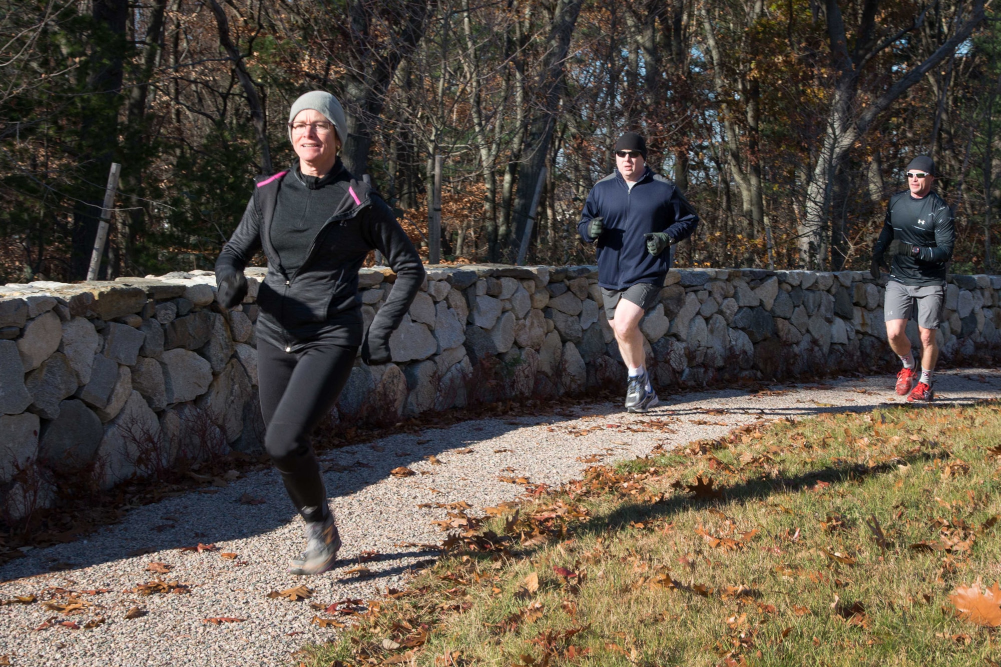 Diane Zamot, Dave Shannon and Brent Hickman run along a path on base during the Fitness and Sports Center Turkey Trot 5K, Nov. 19. The overall top male finisher was Erik Limpaecher with a time of 19 minutes 27 seconds. The overall top female finisher was Zamot with a time of 25 minutes and 30 seconds. (U.S. Air Force photo by Mark Herlihy)