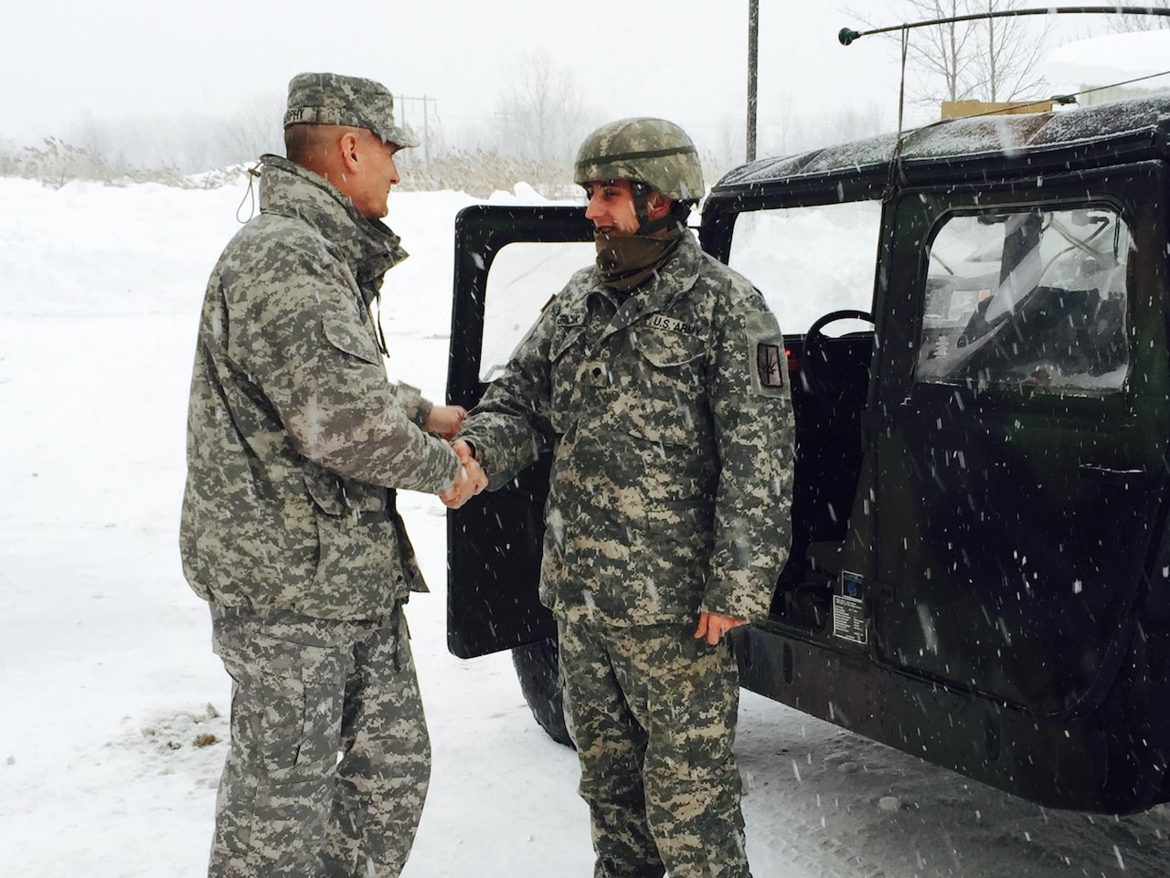 Army Maj. Gen. Patrick Murphy, left, New York’s adjutant general, congratulates Spc. Alan Pericak of the New York Army National Guard’s 152nd Engineer Company, Nov. 19, 2014, following his successful mission to drive New York Gov. Andrew Cuomo through areas paralyzed by historic snowfall. Pericak, from West Falls, N.Y., is part of the governor's mobilization of more than 340 National Guard soldiers and airmen from area units to assist local authorities with snow removal or traffic control across regions of western New York hit by a historic snowstorm. U.S. Army photo by Maj. Mark Frank