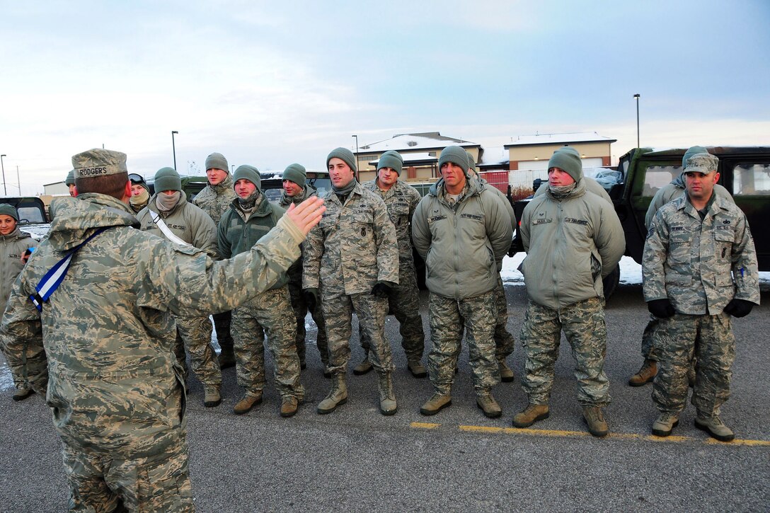 Air Force Master Sgt. Thomas Rodgers, lower left, briefs airmen before leaving to remove snow from the roof of the Eden Heights Assisted Living Facility in West Seneca, N.Y., Nov. 19, 2014. Rodgers and the airman are assigned to the 107th Airlift Wing based in Niagara Falls, N.Y. 