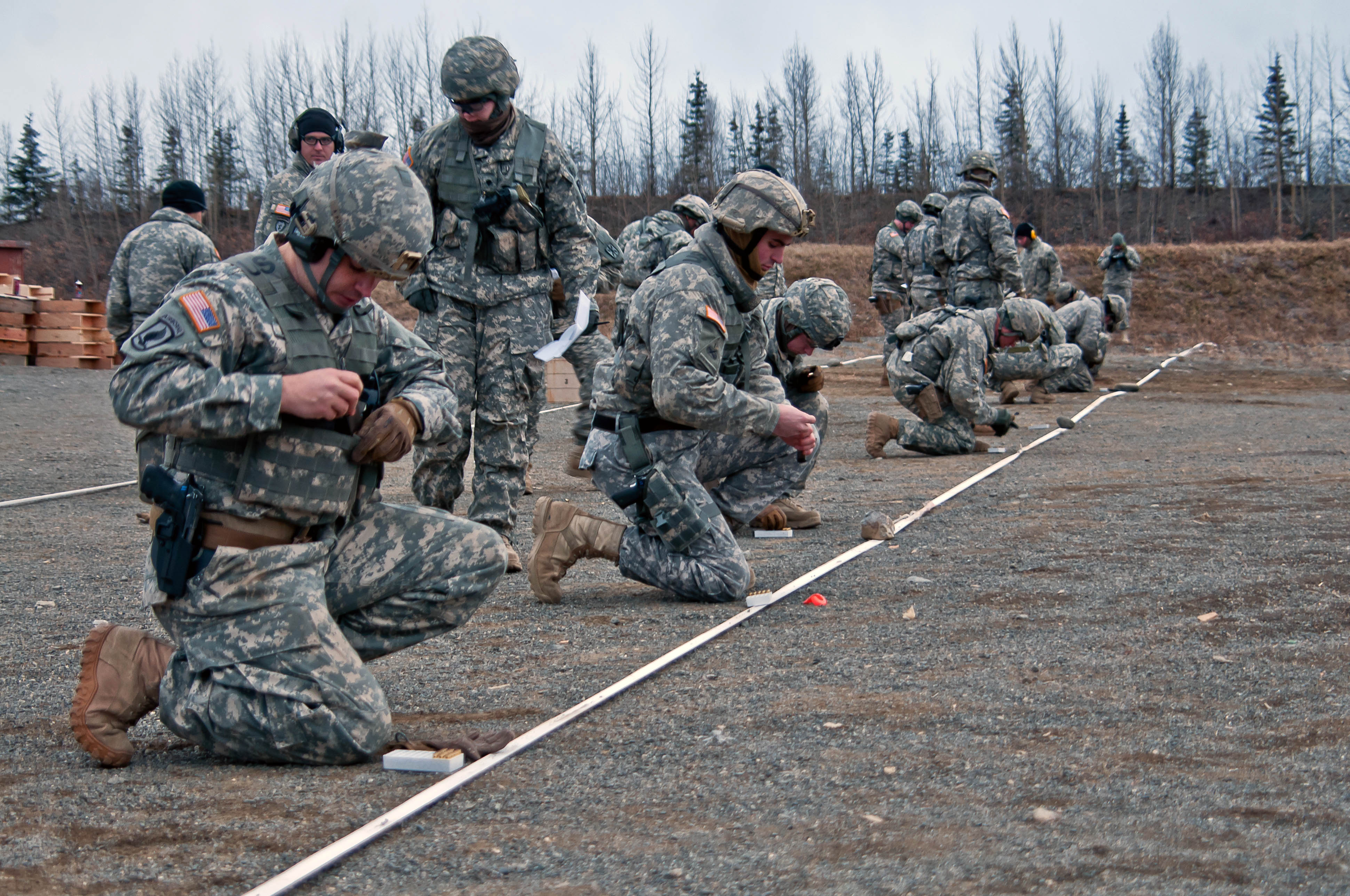 Soldiers load ammunition into their magazines during the U.S. Army