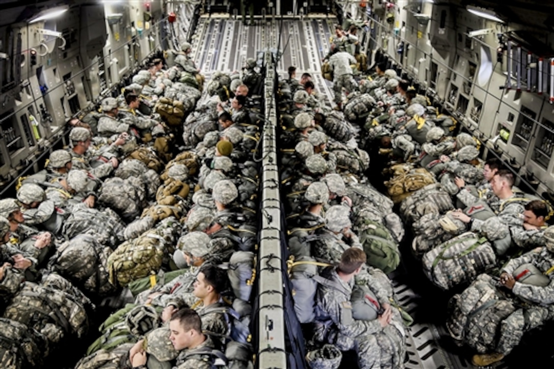 Soldiers wait to take off for a training jump in Austin, Texas, Nov. 14, 2014. The battalion departed Austin’s Bergstrom International Airport on two Altus Air Force Based C-17s, flew to Fort Hood, and then jumped into the Rapido drop zone wearing full combat gear. The soldiers are assigned to 1st Battalion, 143rd Infantry Regiment.  