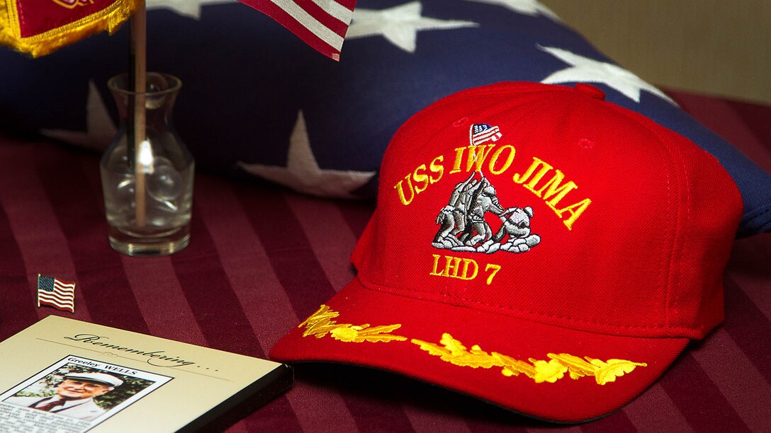 A hat depicting the Iwo Jima flag raising rests on display at a memorial for U.S. Marine 1st Lt. George Greeley Wells in Bellevue, Wash., Oct. 25, 2014. Greeley served as the adjutant of 2nd Battalion, 28th Marine Regiment, 5th Marine Division, during World War II’s famed Battle of Iwo Jima. He carried the first flag that was raised on Mt. Suribachi, a moment later captured by Associated Press photographer Joe Rosenthal in the war’s most famous photo. In the 1990s and early 2000s, he was featuring in James Bradley’s best-selling book “Flags of Our Fathers” and “War Stories with Oliver North,” produced by the retired Marine and Fox News correspondent. Greeley, a native of Lake Forest, Ill., moved with his family from Harding Township, N.J., to Bellevue in the early 2000s. At 94, he passed away in his sleep here Sept. 22, 2014. 