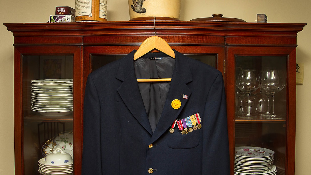 A suit jacket adorned with military awards earned by U.S. Marine 1st Lt. George Greeley Wells hangs in the home of his daughter Barbara Kenney in Bellevue, Washington, Oct. 25, 2014. Greeley served as the adjutant of 2nd Battalion, 28th Marine Regiment, 5th Marine Division, during World War II’s famed Battle of Iwo Jima. He carried the first flag that was raised on Mt. Suribachi, a moment later captured by Associated Press photographer Joe Rosenthal in the war’s most famous photo. In the 1990s and early 2000s, he was featured in James Bradley’s best-selling book “Flags of Our Fathers” and “War Stories with Oliver North,” produced by the retired Marine and Fox News correspondent. Greeley, a native of Lake Forest, Illinois, moved with his family from Harding Township, New Jersey, to Bellevue in the early 2000s. At 94, he passed away in his sleep here Sept. 22, 2014. 