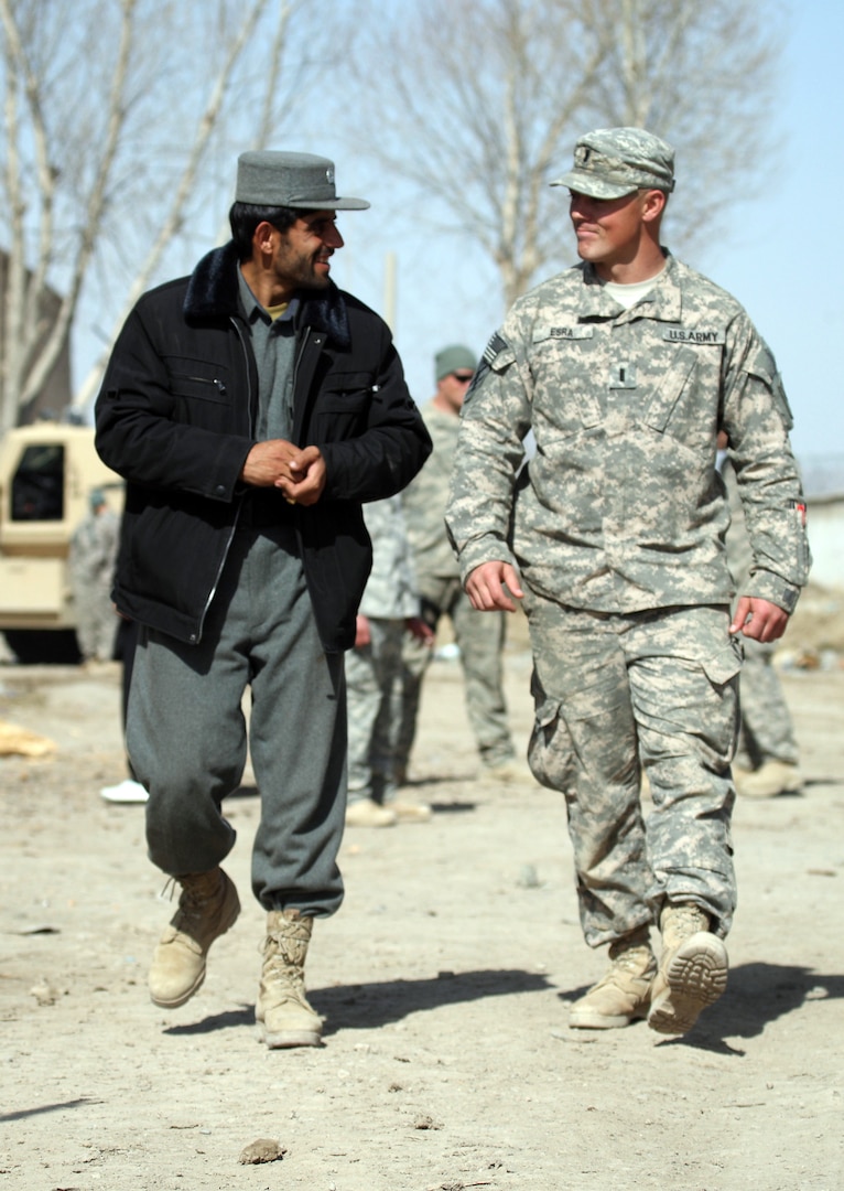 1st Lt. David Esra, right, speaks with the new Qara Bagh District Chief of Police Afghan National Police 3rd Lt. Abdul Rauf at the Qara Bagh District Center in Ghazni province, Afghanistan, Feb. 21, 2010. Esra is the platoon leader of 3rd Platoon, Company D, 1st Battalion, 121st Infantry Regiment, 48th Infantry Brigade Combat Team of the Georgia Army National Guard.