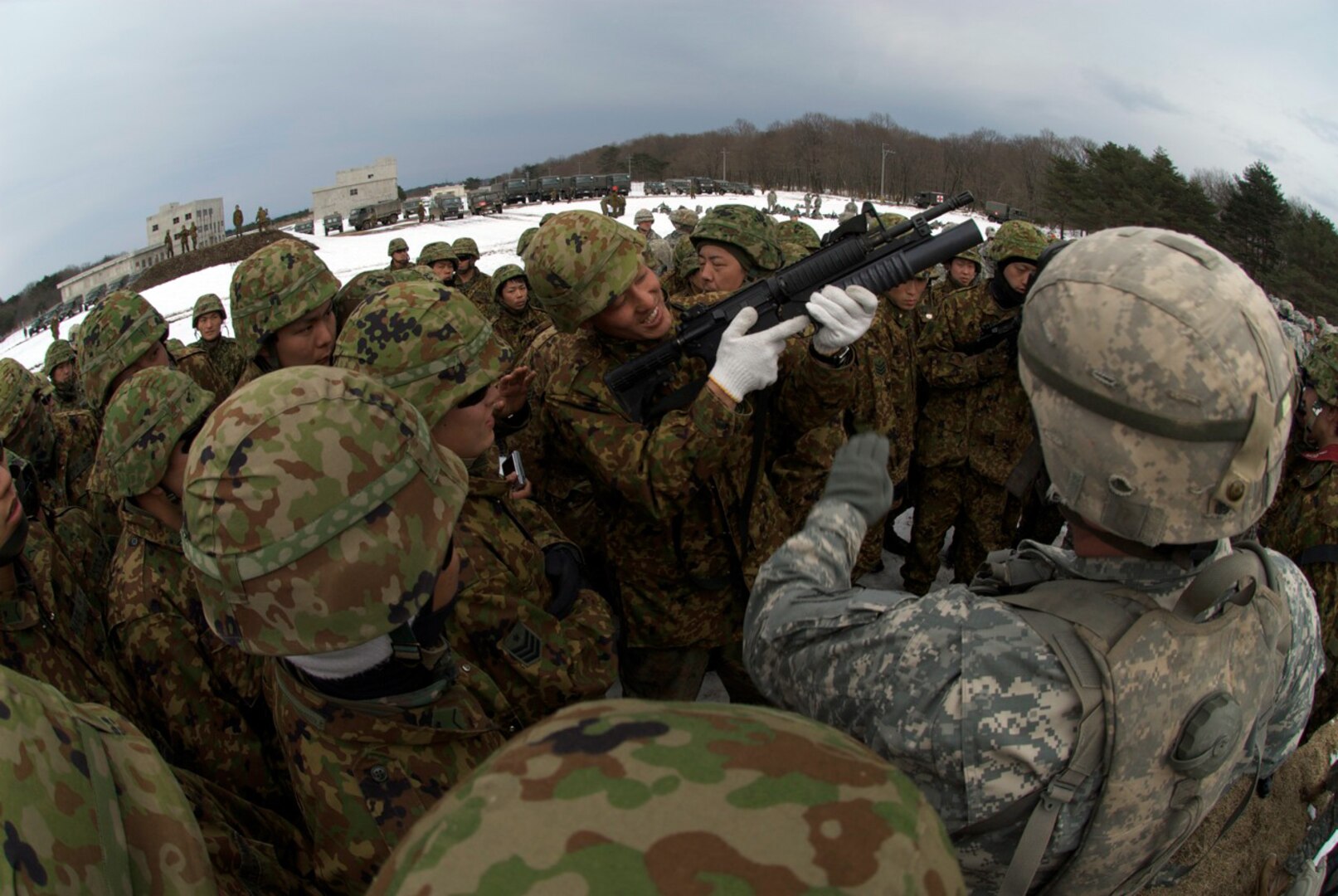 South Carolina Army National Guard infantryman instruct Japanese soldiers on the use and technical characteristics of the M-203 grenade launcher at one of the firing ranges located on Ojojibara Maneuver Area in Sendai, Japan, on Feb. 11, 2010. The practical demonstration was part of FTX North Wind 2010.