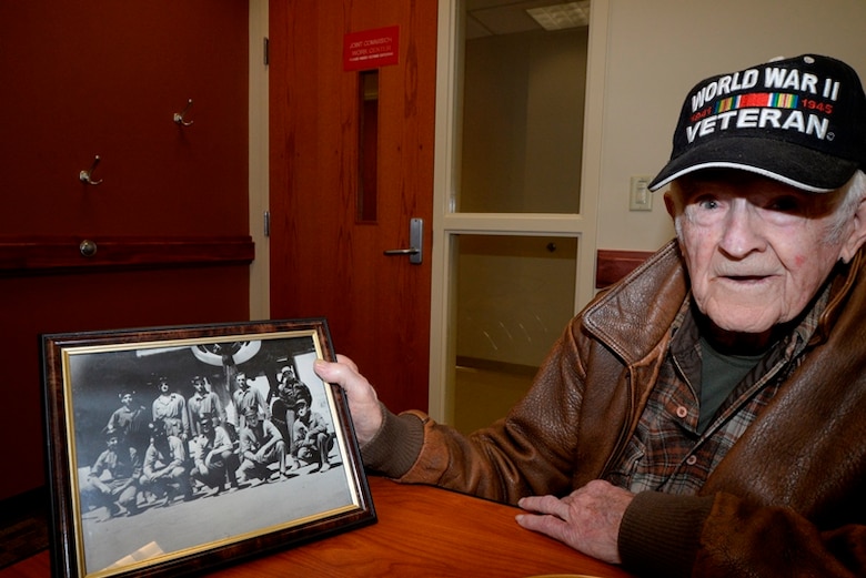 Retired Chief Master Sgt. Blaine Yelton displays a photo of his crew, Nov. 12, 2014, at Joint Base Charleston, S.C. Yelton, now 99 years old, served in the Army Air Corps during World War II and in the Air Force during the wars in Korea and Vietnam. (U.S. Air Force photo/Eric Sesit)