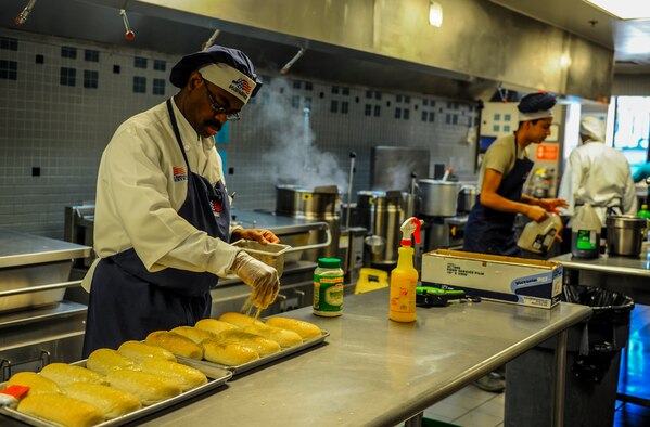 Barry Smith, a 1st Special Operations Force Support Squadron cook, sprinkles spices over bread at the Reef Dining Facility on Hurlburt Field, Fla., Nov. 21, 2014. The Reef is one of two dining facilities at Hurlburt Field. (U.S. Air Force photo/Senior Airman Christopher Callaway)