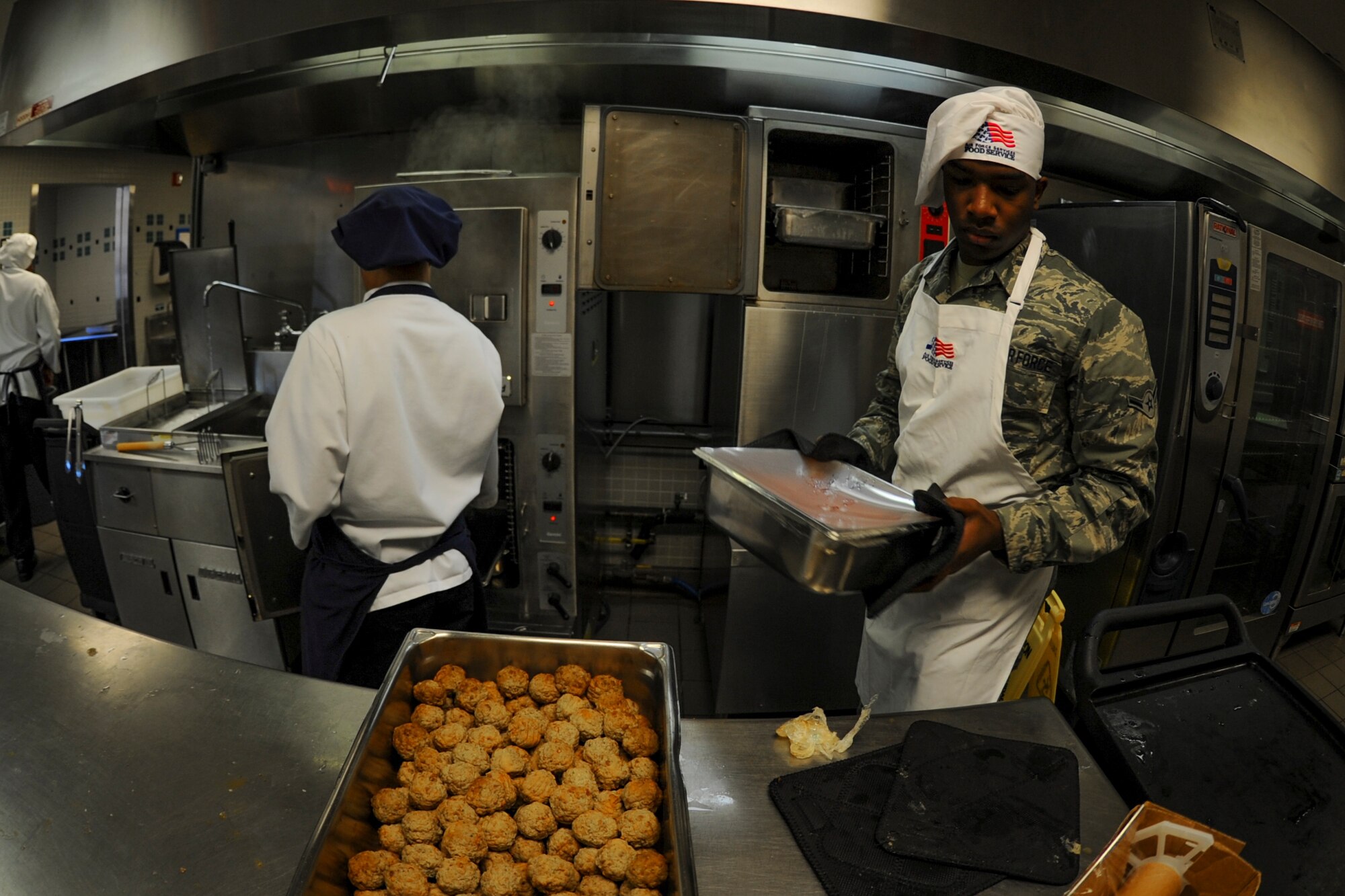 Airman Ronald Dobbins, 1st Special Operations Force Support Squadron food services journeyman, carries sauce at the Reef Dining Facility on Hurlburt Field, Fla., Nov. 21, 2014. The Reef is open for breakfast, lunch and dinner, and any Department of Defense cardholder may eat there. (U.S. Air Force photo/Senior Airman Christopher Callaway)