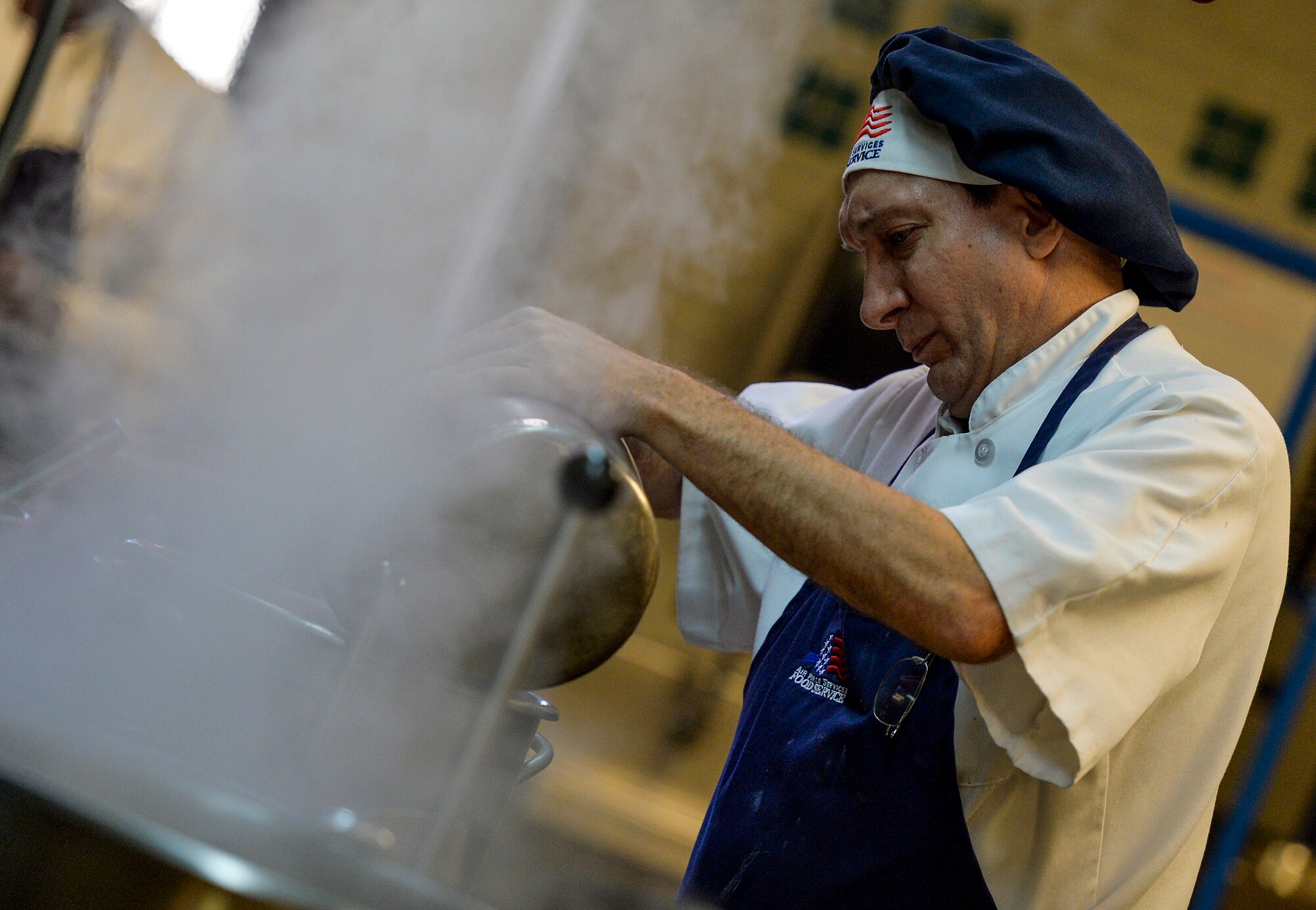 Lee Eagleson, 1st Special Operations Force Support Squadron cook, dumps sauce into a pot at the Reef Dining Facility on Hurlburt Field, Fla., Nov. 21, 2014. The Reef is one of two dining facilities available to Hurlburt personnel. (U.S. Air Force photo/Senior Airman Christopher Callaway)