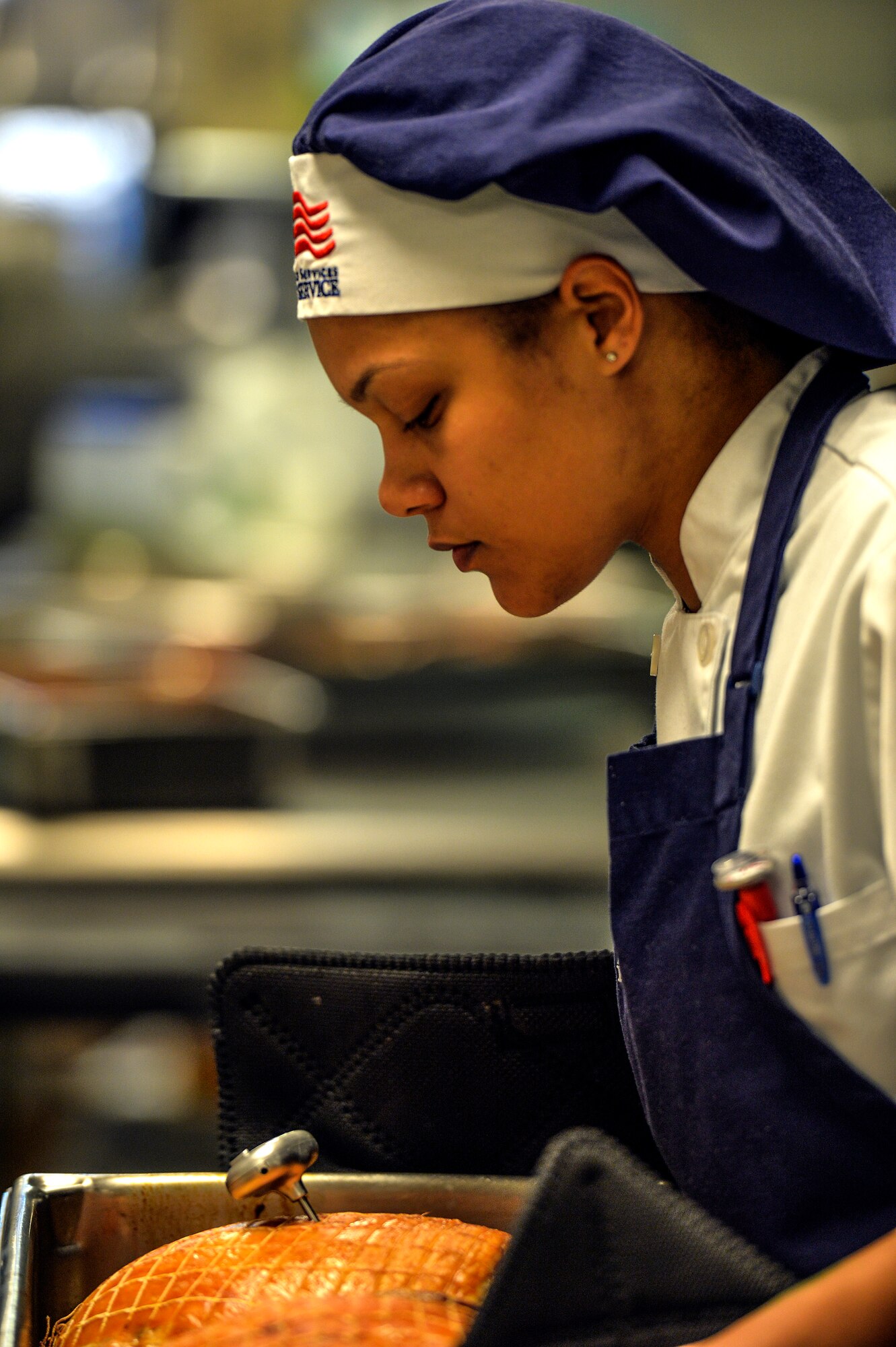 Nikita Gillison, 1st Special Operations Force Support Squadron cook, checks a thermometer while preparing lunch at the Reef Dining Facility on Hurlburt Field, Fla., Nov 21., 2014. The Reef is one of two dining facilities available to Hurlburt personnel. (U.S. Air Force photo/Senior Airman Christopher Callaway)