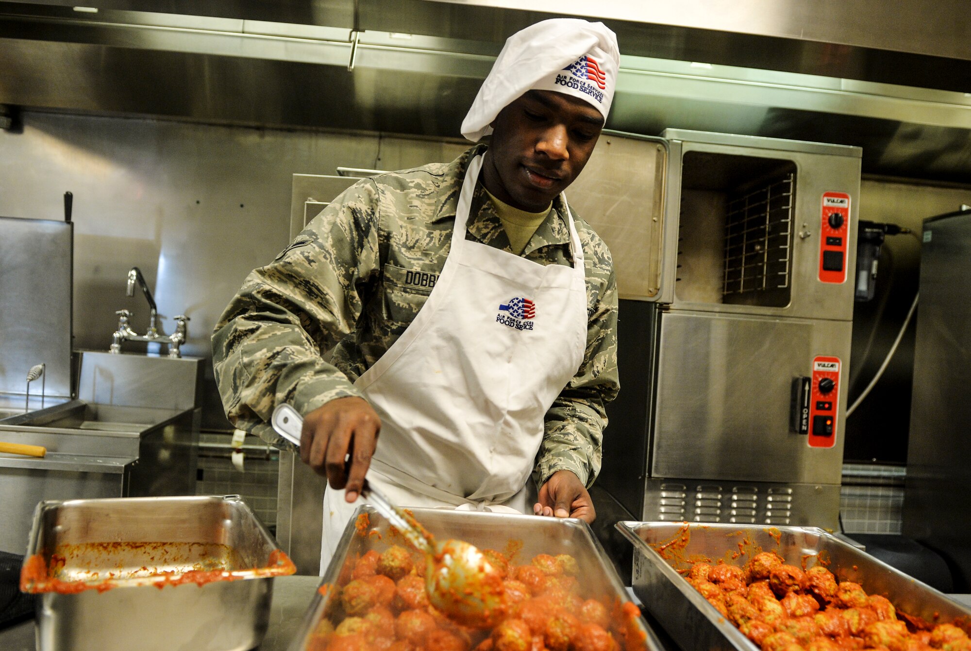 Airman Ronald Dobbins, 1st Special Operations Force Support Squadron food services journeyman, stirs meatballs at the Reef Dining Facility on Hurlburt Field, Fla., Nov. 21, 2014. The Reef is one of two dining facilities available to Hurlburt personnel. (U.S. Air Force photo/Senior Airman Christopher Callaway)