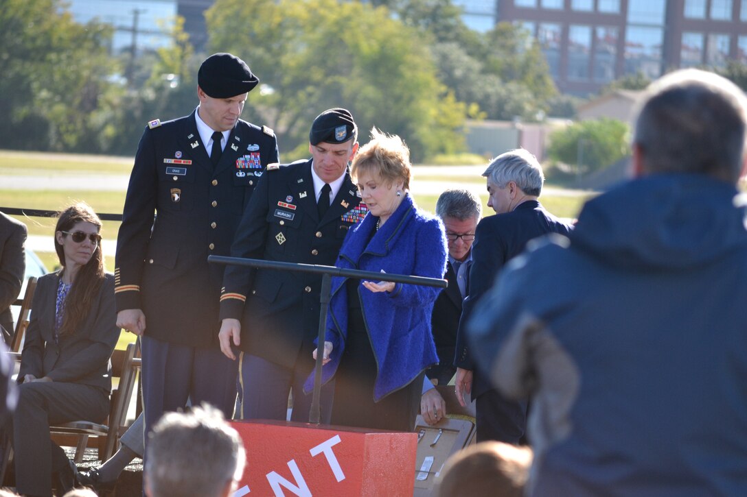 Acting Fort Worth District Commander Lt. Col. Neil Craig and Acting Southwestern Division Commander Col. Richard Muraski help Congresswomen Kay Granger and other dignitaries during an explosive groundbreaking ceremony Oct. 10 for the future Panther Island Bridges. The bridges will be built over dry land to save money and allow the Trinity River Vision Project to progress forward.