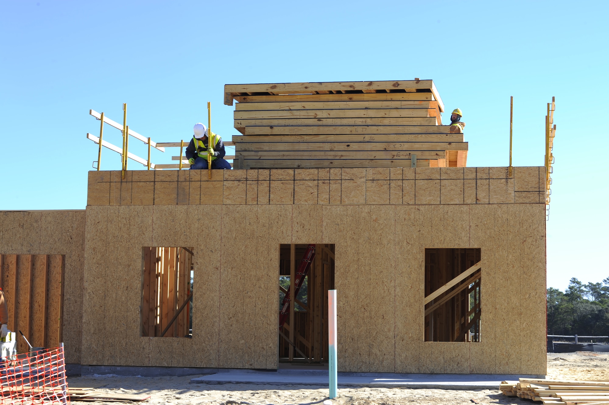 A construction worker puts up safety railings on a house in the Osprey Landing Neighborhood on Hurlburt Field, Fla., Nov. 18, 2014. The neighborhood will consist of 63 new, single family homes for senior non-commissioned officers and chief master sergeants. (U.S. Air Force photo/Staff Sgt. Sarah Hanson)