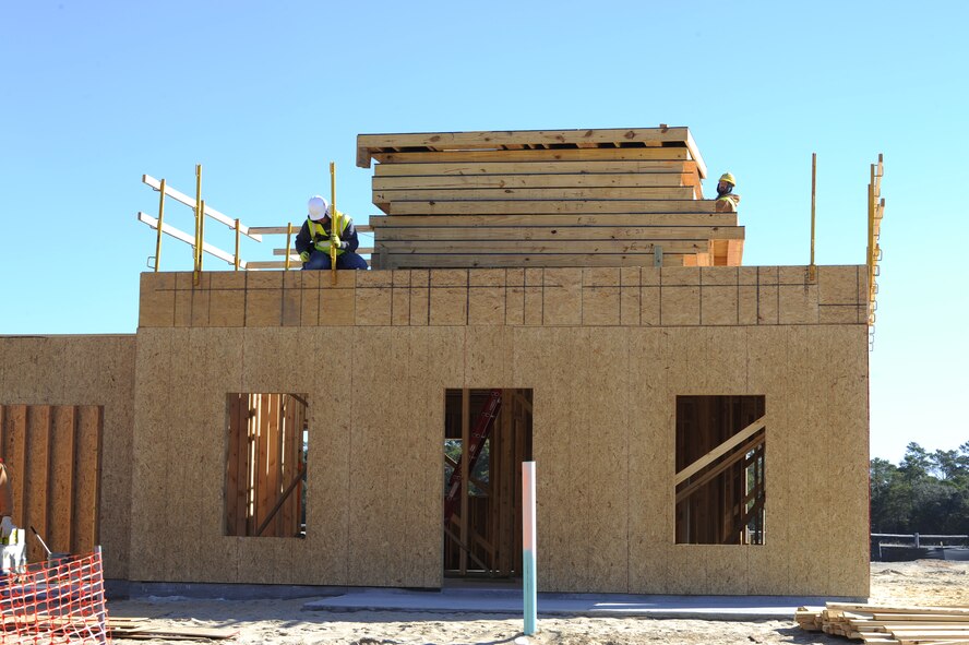 A construction worker puts up safety railings on a house in the Osprey Landing Neighborhood on Hurlburt Field, Fla., Nov. 18, 2014. The neighborhood will consist of 63 new, single family homes for senior non-commissioned officers and chief master sergeants. (U.S. Air Force photo/Staff Sgt. Sarah Hanson)